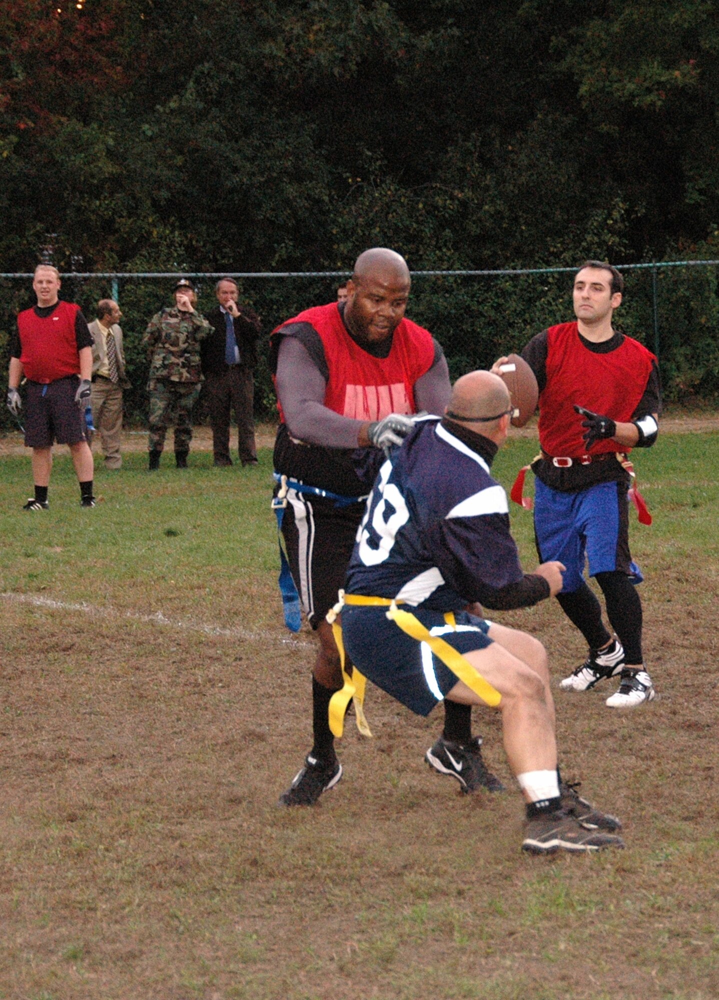 Right, 653rd Electronic Systems Wing flag football team quarterback looks down field for an open receiver as his offensive lineman blocks an Air Force Research Laboratory pass rusher during the Intramural Flag Football Championship game on base Oct. 15. (U.S. Air Force photo by Dennis Lewis)
