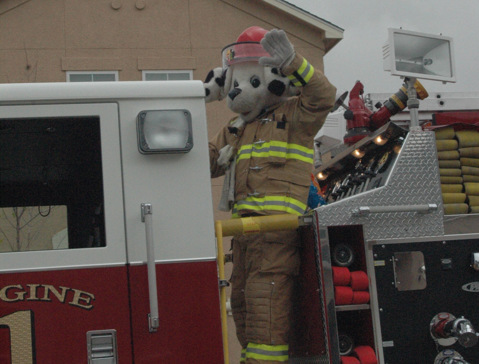 BUCKLEY AIR FORCE BASE, Colo. -- Sparky the Fire Dog waves at Buckley housing residents Oct. 13 during a fire truck parade. The fire department hosted an open house and conducted a fire truck parade through base housing that day to celebrate the ending of fire prevention week. (U.S. Air Force photo by Senior Airman Jacque Lickteig)