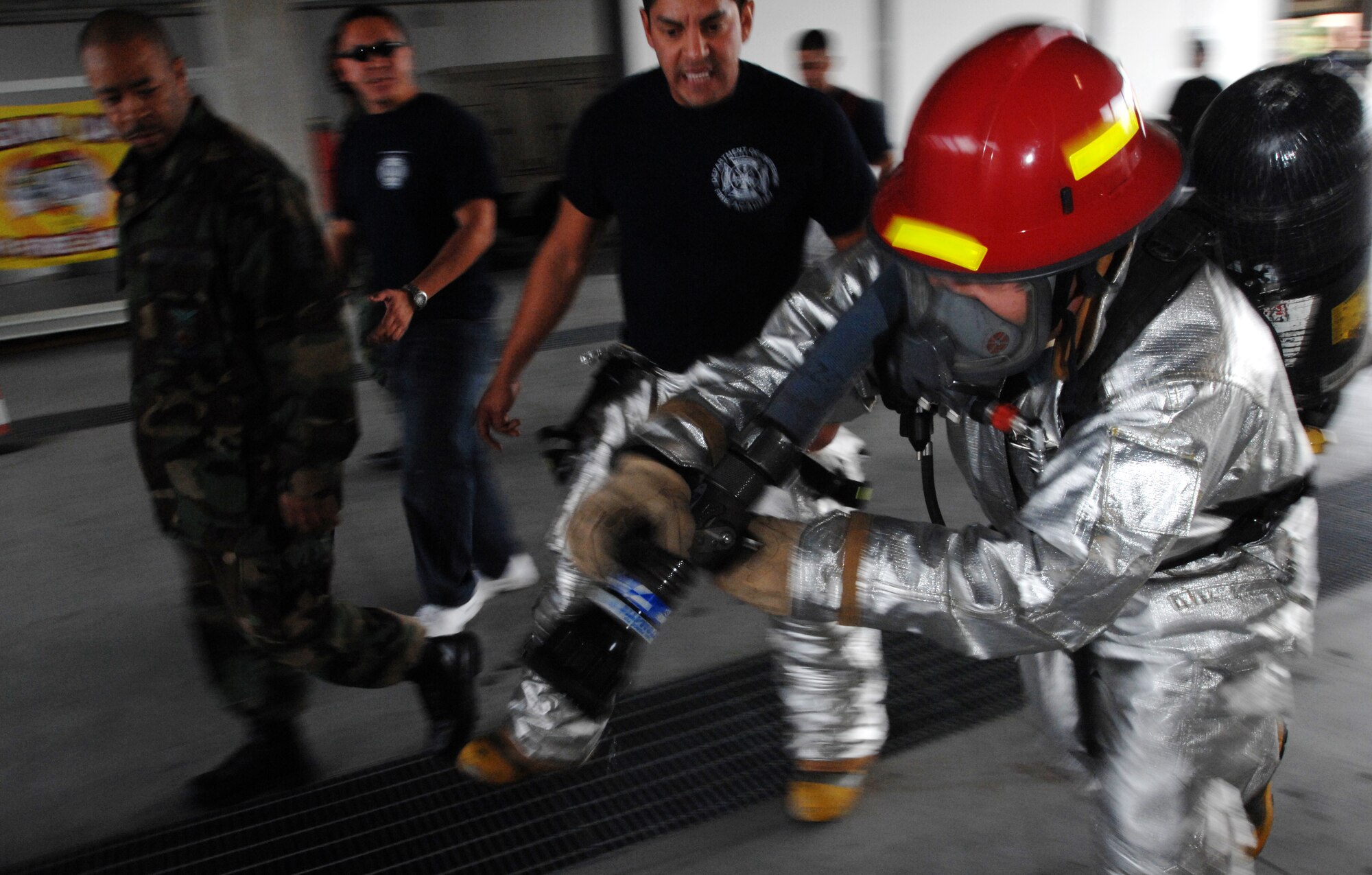 Aviano Air Base, Italy-- Col. David Slade, 31st Mission Support Group Commander, competes in the Commander's Firefighter's Challenge Oct. 12, 2007.  Group and Squadron commanders got together to celebrate Fire Safety Week by competing in various firefighting obstacle courses.  ( U.S. Air Force photo/Airman First Class Nathan Doza ) ( Released )