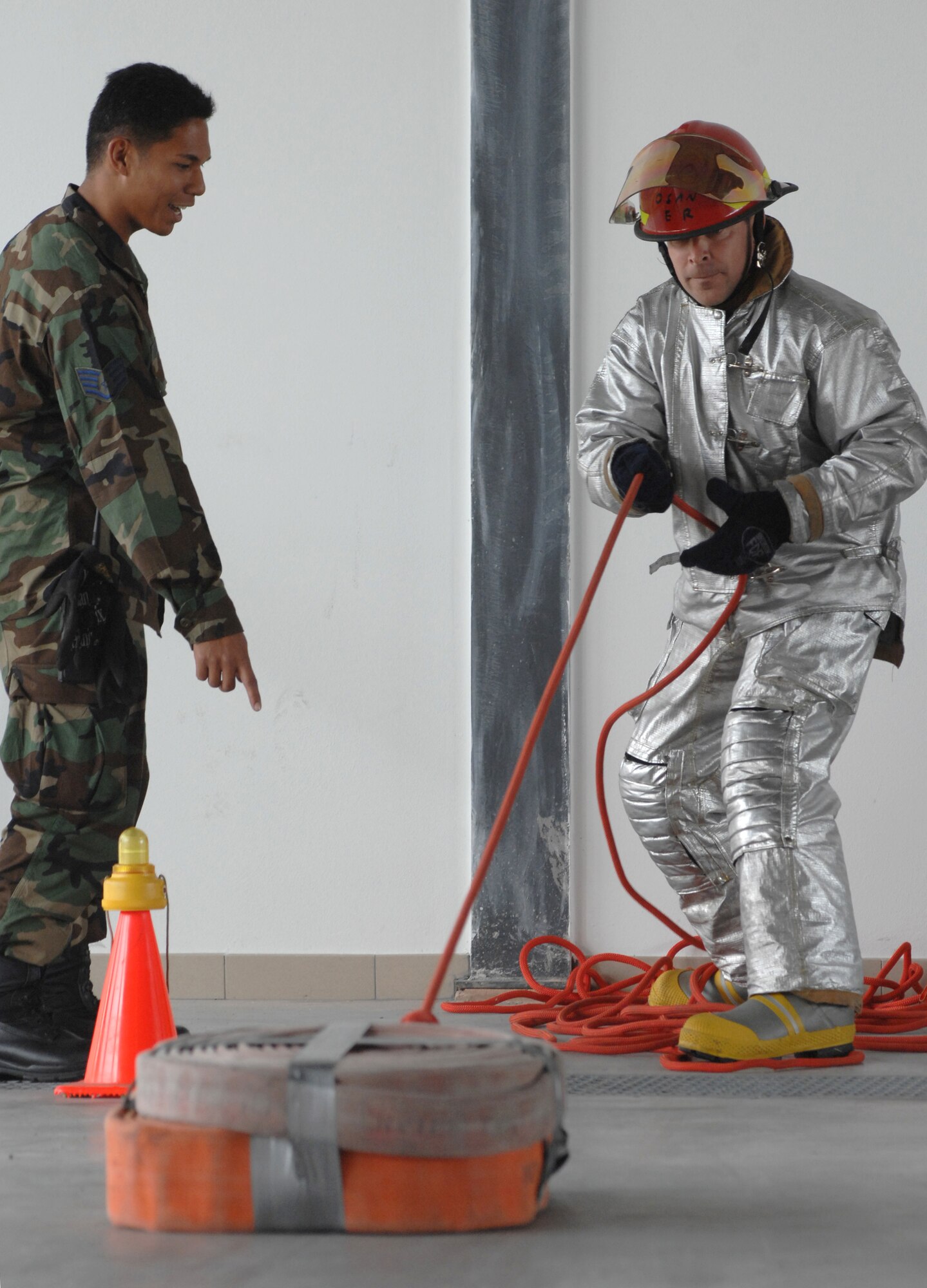 AVIANO AIR BASE, Italy-- Col. David Slade, 31st Mission Support Group commander, competes in the Commander's Firefighter's Challenge Oct. 12, 2007.  Group and Squadron commanders got together to celebrate Fire Safety Week by competing in various firefighting obstacle courses.  (U.S. Air Force photo/Airman 1st Class Nathan Doza)