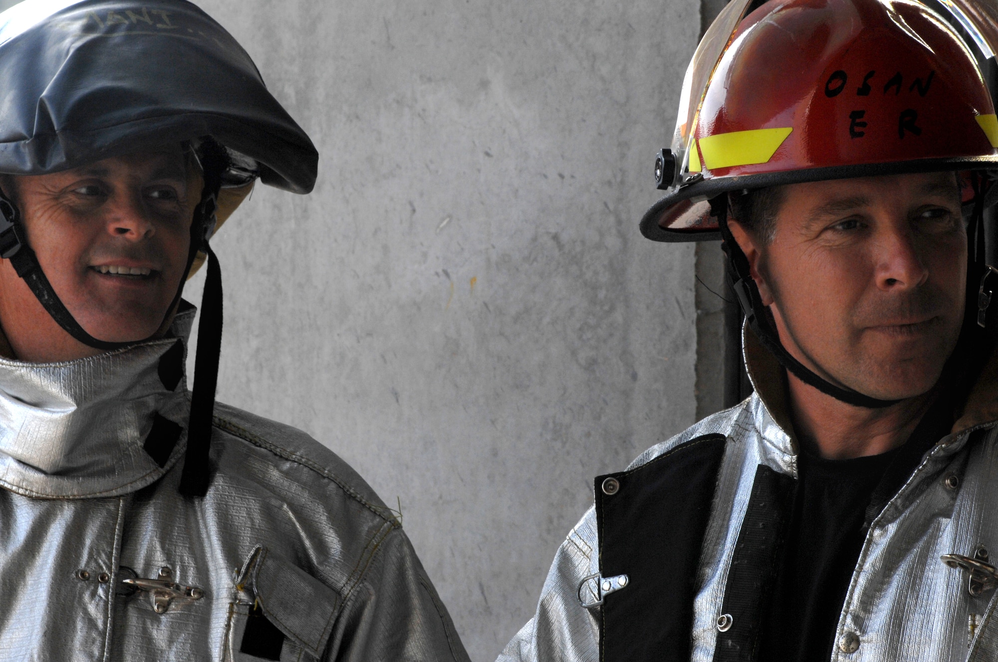 Aviano Air Base, Italy-- Lt. Col. Jimmy Browning, 31st Fighter Wing Chaplain, and Col.  David Slade, 31st Mission Support Group Commander, compete in the Commander's Firefighter's Challenge Oct. 12, 2007.  Group and Squadron commanders got together to celebrate Fire Safety Week by competing in various firefighting obstacle courses.  ( U.S. Air Force photo/Airman First Class Nathan Doza ) ( Released )