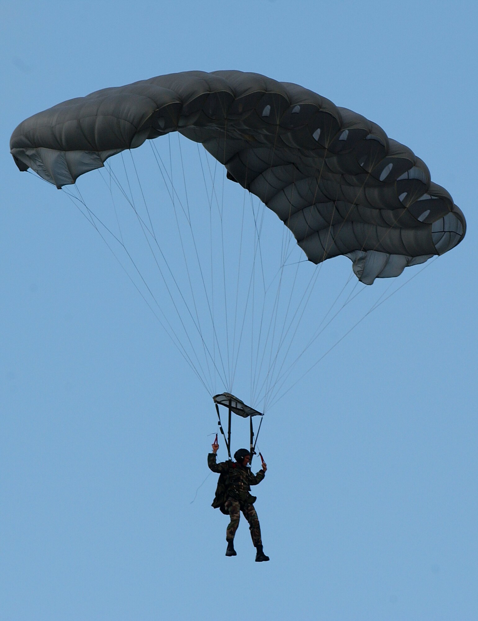 A pararescueman conducts a parachute drop Oct. 19 on Kadena AB, Japan. The Airmen train together in order to maintain operational readiness for the defense of Japan and to meet United States obligations. The pararescuemen are capable of conducting search and rescue missions under any conditions and have saved the lives of both U.S. military and Japanese citizens in Okinawa.   
(U.S. Air Force photo/Tech. Sgt. Reynaldo Ramon)

