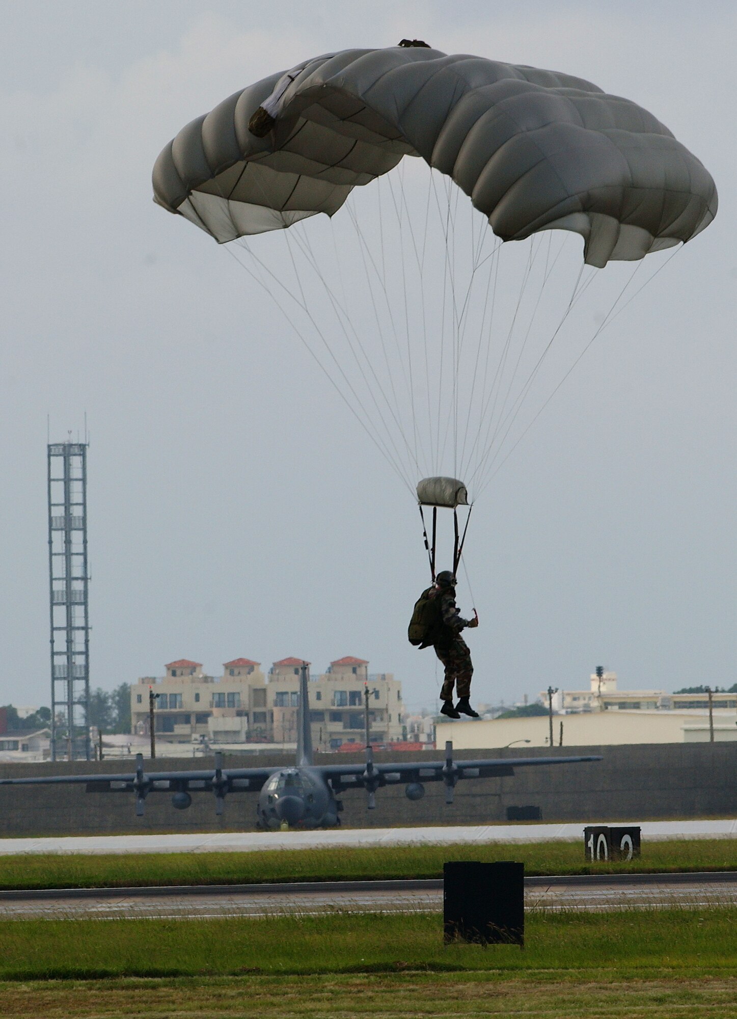 A pararescueman conducts a parachute drop Oct. 19 on Kadena AB, Japan.  The Airmen train together in order to maintain operational readiness for the defense of Japan and to meet United States obligations. The pararescuemen are capable of conducting search and rescue missions under any conditions and have saved the lives of both U.S. military and Japanese citizens in Okinawa.   
(U.S. Air Force photo/Tech. Sgt. Reynaldo Ramon)

