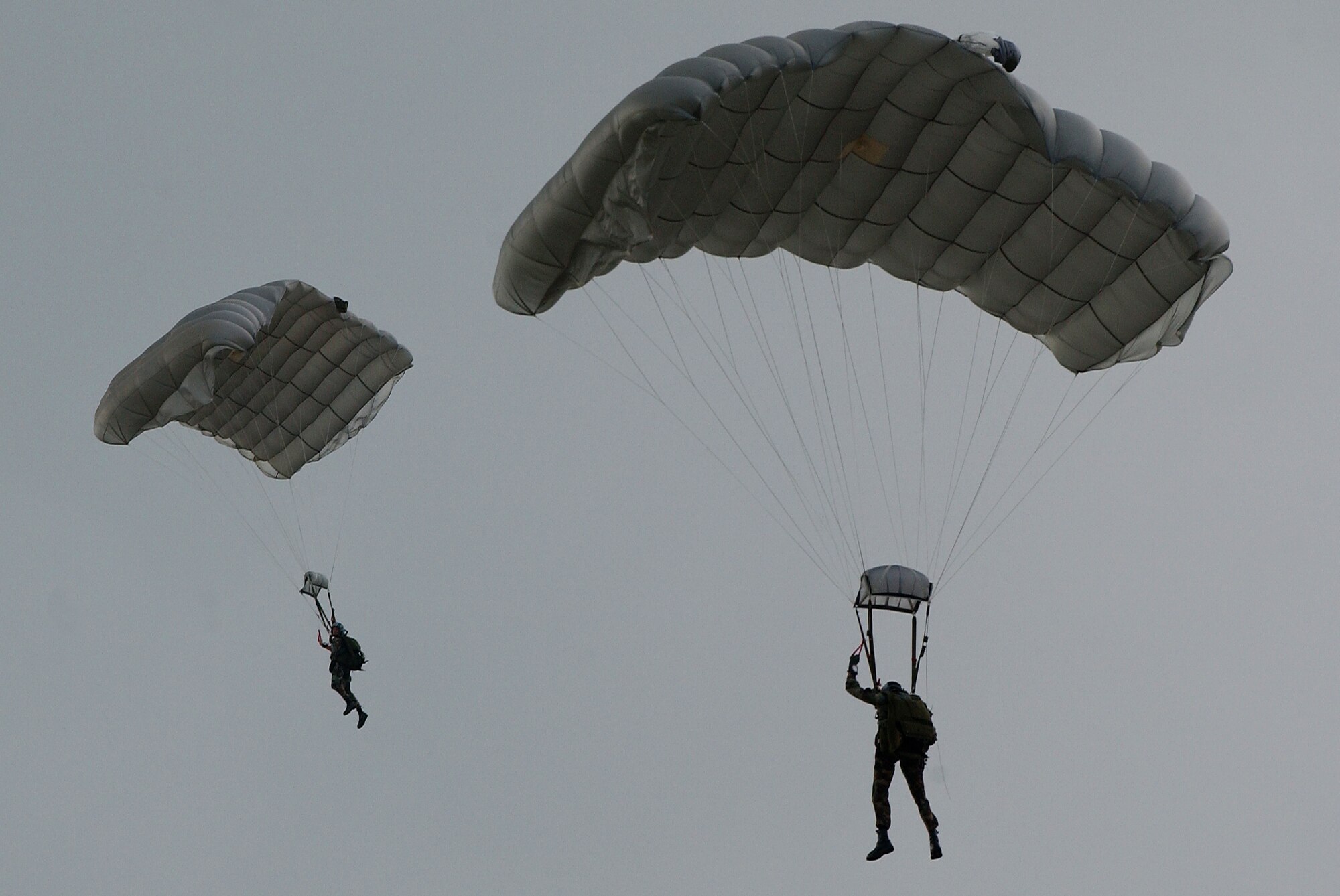 Pararescuemen conduct a parachute drop Oct. 19 on Kadena AB, Japan.  The Airmen train in order to maintain operational readiness for the defense of Japan and to meet United States obligations. The pararescuemen are capable of conducting search and rescue missions under any conditions and have saved the lives of both U.S. military and Japanese citizens in Okinawa.   
(U.S. Air Force photo/Tech. Sgt. Reynaldo Ramon)

