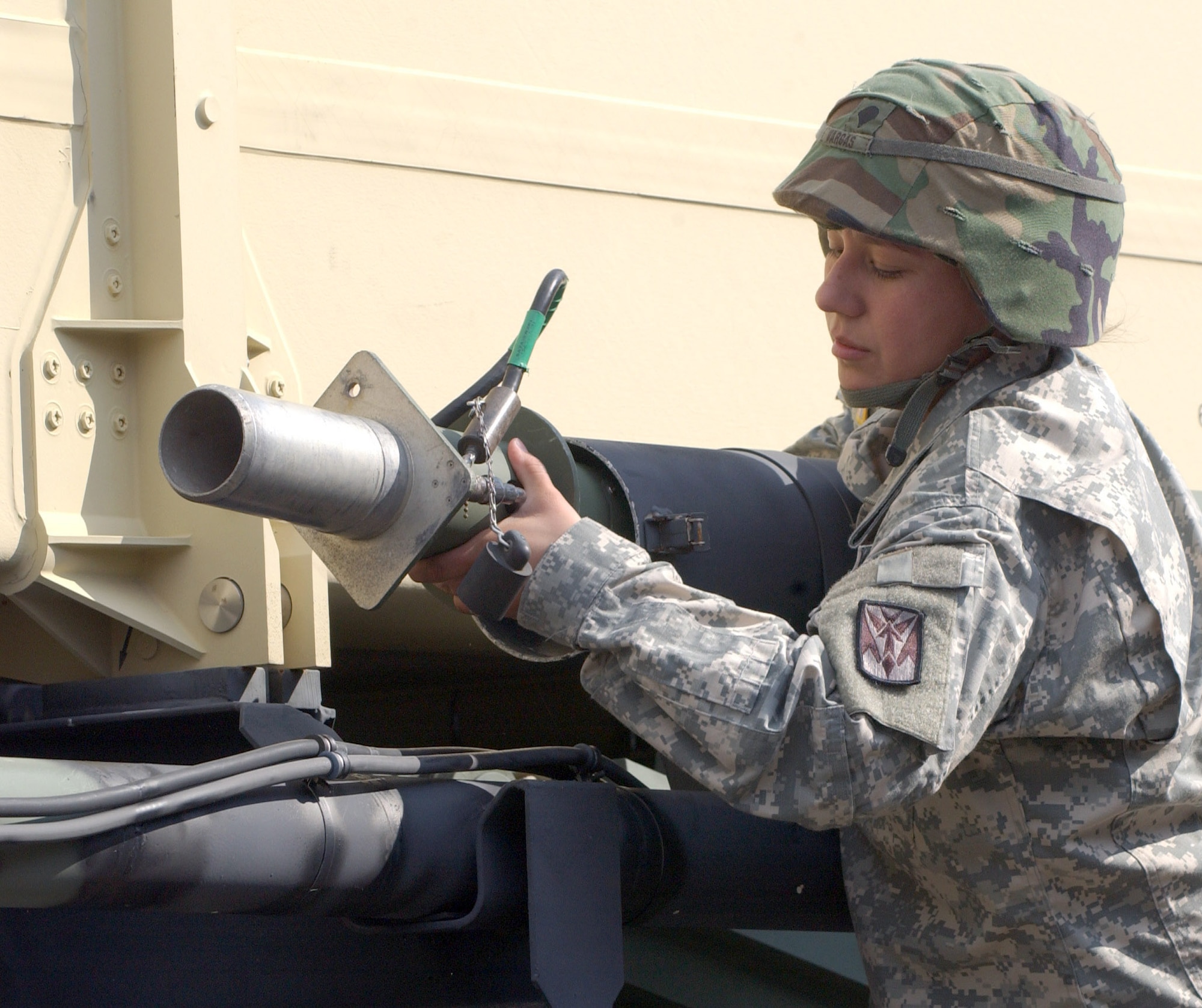KUNSAN AIR BASE, South Korea -- Army Specialist Christine Vargas, a launcher crew member with Charlie 2-1 Air Defense Artillery, removes an antenna from the PATRIOT launcher Oct. 19 here.  The Soldiers of Charlie 2-1 ADA here provide missile defense for the 8th Fighter Wing so runways can remain operational at all times. (U.S. Air Force photo/Senior Airman Steven R. Doty)
