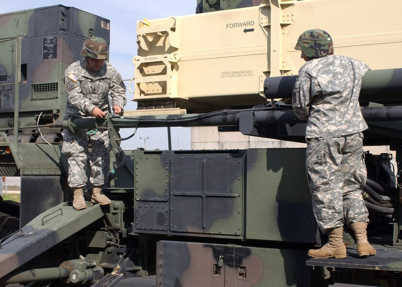KUNSAN AIR BASE, South Korea -- Army Sergeant Frank Tatroe, left, and Specialist Christine Vargas, right, both launcher crew members with Charlie 2-1 Air Defense Artillery, prepare to remove an antenna from the Patriot launcher Oct. 19 here.  The Soldiers of Charlie 2-1 ADA here provide missile defense for the 8th Fighter Wing so runways can remain operational at all times. (U.S. Air Force photo/Senior Airman Steven R. Doty)                               