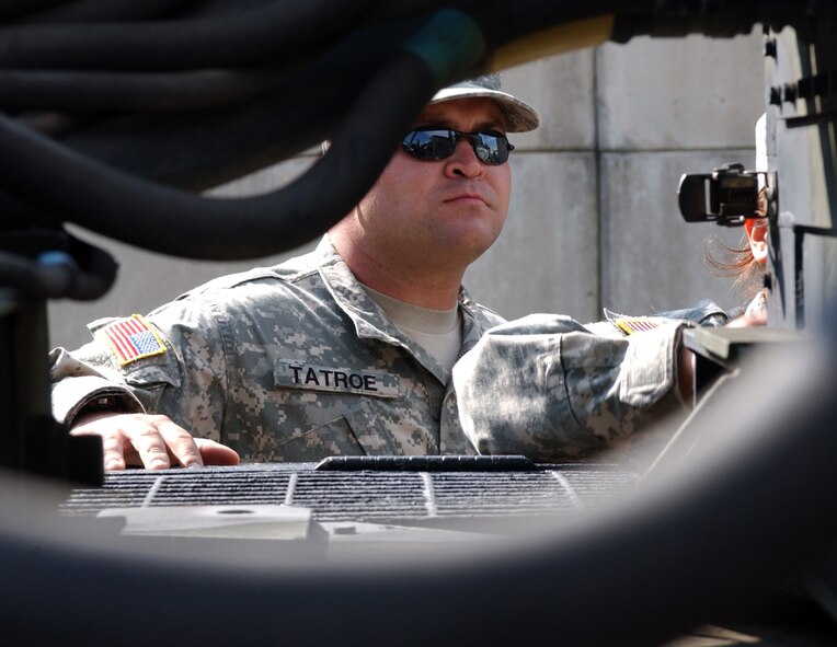 KUNSAN AIR BASE, South Korea -- Army Sergeant Frank Tatroe, a launcher crew member with Charlie 2-1 Air Defense Artillery, observes Army Specialist Christine Vargas as she operates the PATRIOT launcher system for training purposes here Oct. 19.  The Soldiers of Charlie 2-1 ADA here provide missile defense for the 8th Fighter Wing so runways can remain operational at all times. (U.S. Air Force photo/Senior Airman Steven R. Doty)