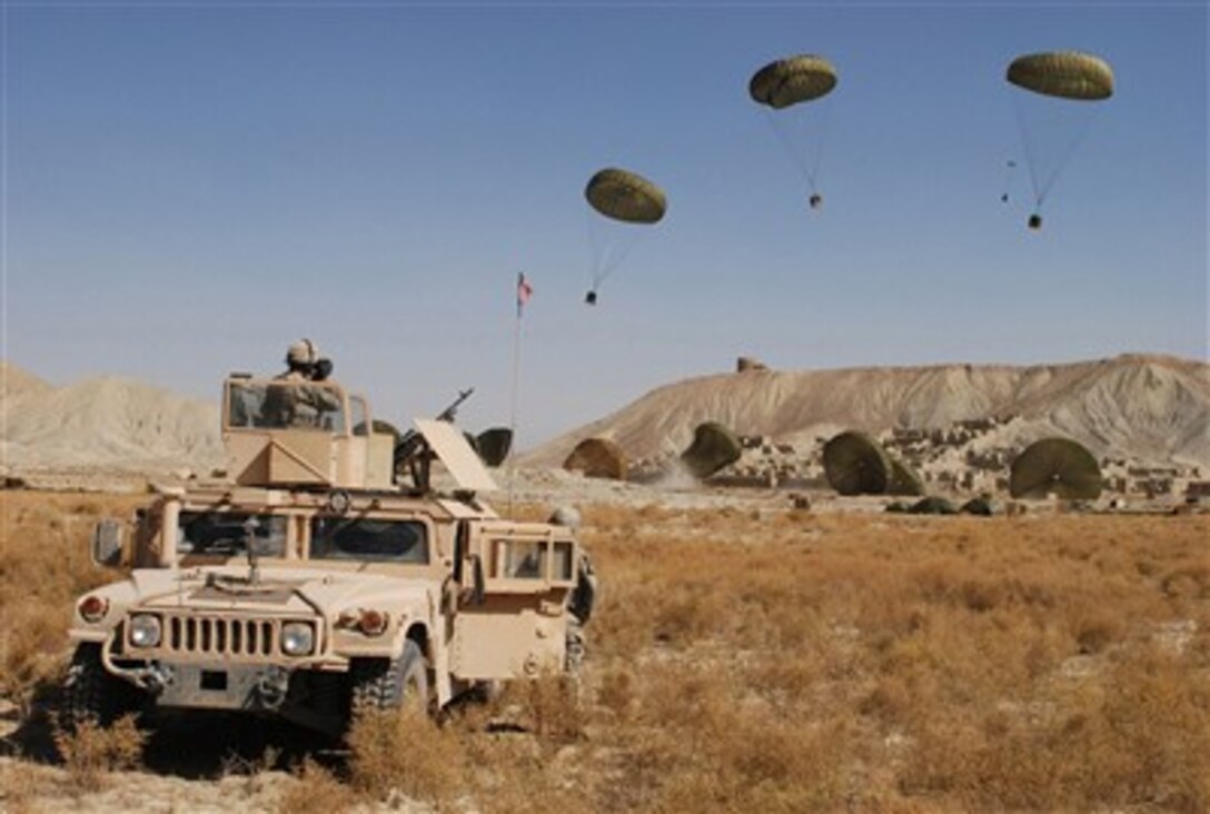 Paratroopers from the 782nd Brigade Support Battalion, 4th Brigade Combat Team, 82nd Airborne Division watch as combat delivery system bundles carrying food and water come floating to the ground in the Paktika province of Afghanistan on Oct. 11, 2007.  
