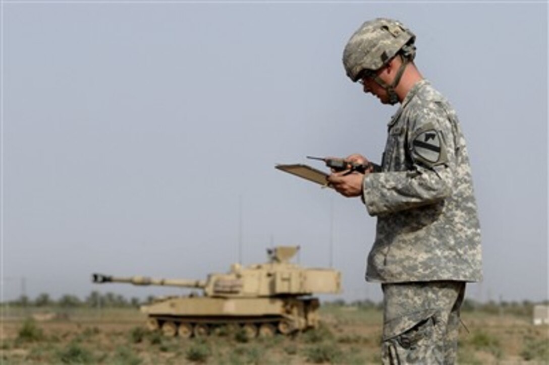 U.S. Army Spc. Ryan Halbrook uses a compass to locate coordinates for an M109-A6 Paladin Self-Propelled Howitzer during a top gun competition on Camp Taji, Iraq, on Oct. 10, 2007.  Halbrook is attached to Alpha Company, 1st Battalion, 82nd Brigade Combat Team, 1st Cavalry Division.  