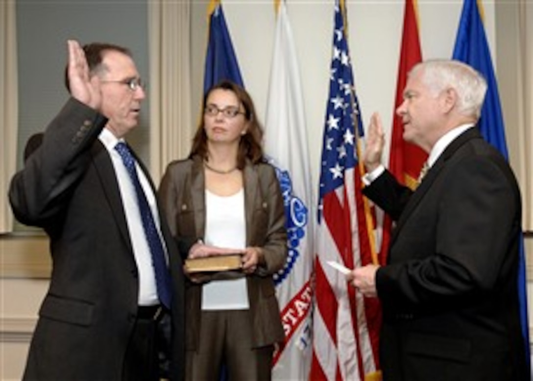 Michael G. Vickers, left, with his wife Melana at his side, takes the oath of office from Defense Secretary Robert M. Gates, right, Oct. 18, 2007, to become the new assistant secretary of defense for special operations and low intensity conflict.