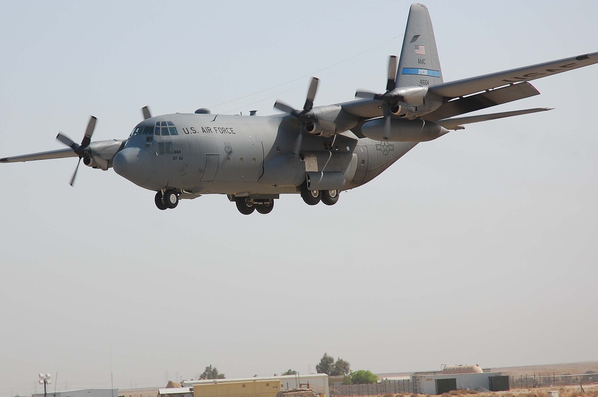 SOUTHWEST ASIA -- A C-130E Hercules from Dyess AFB, Texas, prepares to land during an in-flight emergency here Oct. 19.  The C-130J is the latest addition to the C-130 fleet and will replace aging C-130Es. The C-130J incorporates state-of-the-art technology to reduce manpower requirements, lower operating and support costs, and provides life-cycle cost savings over earlier C-130 models. Compared to older C-130s, the J model climbs faster and higher, flies farther at a higher cruise speed and takes off and lands in a shorter distance.  (U.S. Air Force photo by Staff Sgt. Tia Schroeder)