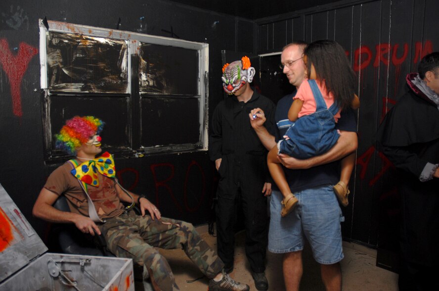 Tech. Sgt. Martin Pitre and his daughter check out the 36th Civil Engineering Squadron's haunted house in base housing Oct. 20.  (U.S. Air Force photo/Senior Airman Miranda Moorer)