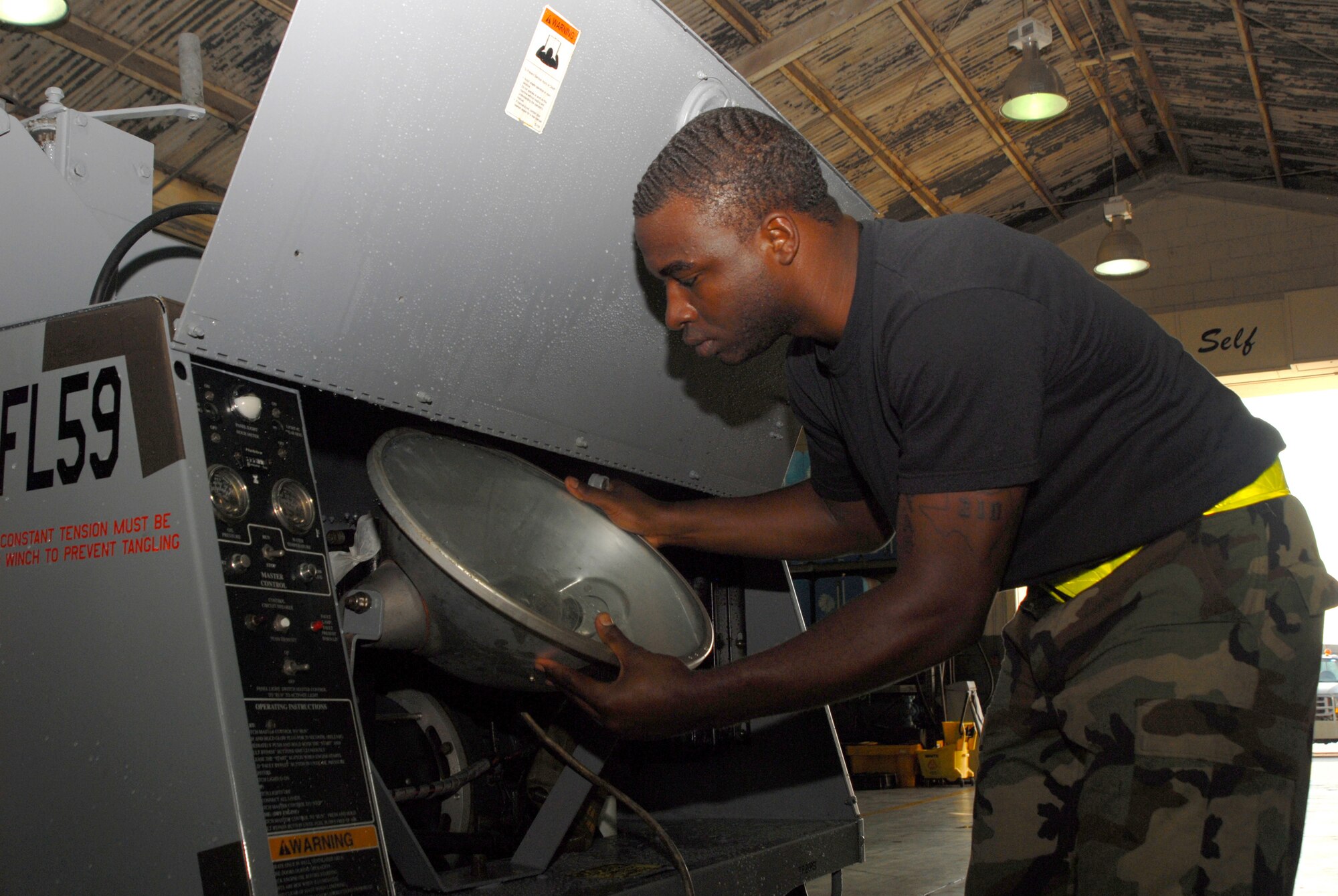 Senior Airman Romaine Hunter, 18th Equipment Maintenance Squadron, installs a light assembly on a piece of aerospace ground equipment during the Local Operational Readiness Exercise Beverly High 08-1 Oct. 22.  (U.S. Air Force photo/Staff Sgt. Chrissy FitzGerald)