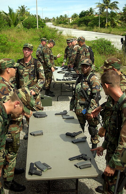 Members of the 36th Contingency Response Group receive instructions at the Combat Arms Training and Maintenance station Oct. 18. (U.S. Air Force Photo/Airman 1st Class Carissa Morgan)