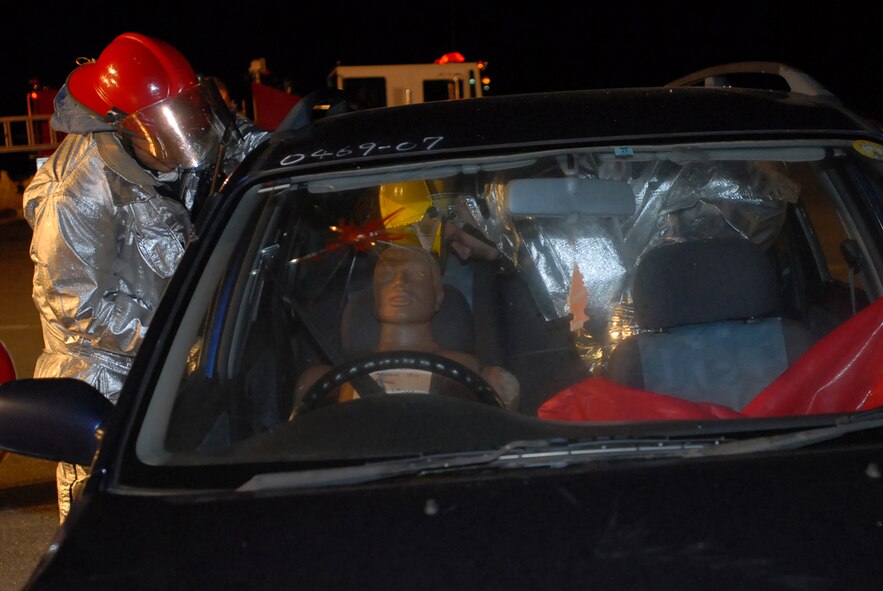 Firefighters from the 18th Civil Engineer Squadron evaluate the best way to pull a trapped “victim” out of a vehicle during Local Operational Readiness Exercise Beverly High 08-1, Oct. 23.  The exercise scenario tested the speed of firefighers to respond, free the victim and administer self-aid and buddy care.  (U.S. Air Force photo/Senior Airman Darnell T. Cannady)