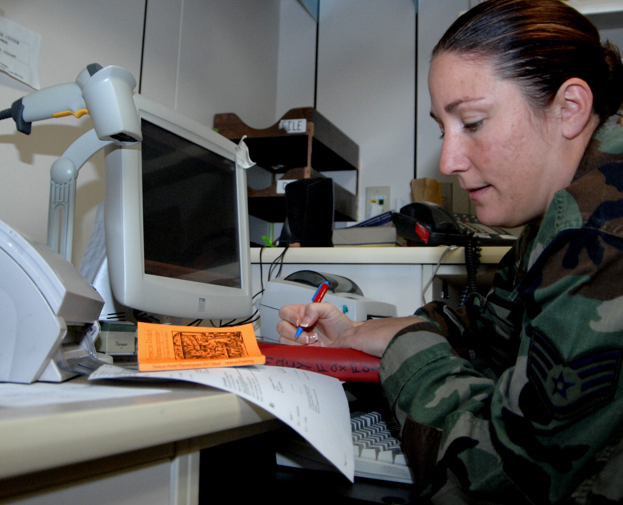 MOUNTAIN HOME AIR FORCE BASE, Idaho -- Staff Sgt. Sherri Griffin, 366th Medical Support Squadron pharmacy technician, looks over patient records in preparation of the Phase I portion of the Sharpshooter Exercise 08-01. The exercise takes place during the October American Pharmacist’s Month. The 2007 theme is “Know Your Medicine - Know Your Pharmacist.” The month celebrates the work of American pharmacists and helps raise awareness about how pharmacists affect patient care. (U.S. Air Force photo/ Airman 1st Class Stephany Miller)