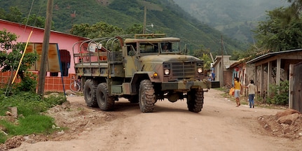 SOTO CANO AIR BASE, Honduras – An Army two-and-a-half-ton troop transport truck rolls through the village of Lejamani as part of a convoy exercise Oct. 19.  The purpose of the training was to keep the vehicles in operation and identify any issues with them so they could be fixed.  (U.S. Air Force photo by Staff Sgt. Austin M. May)