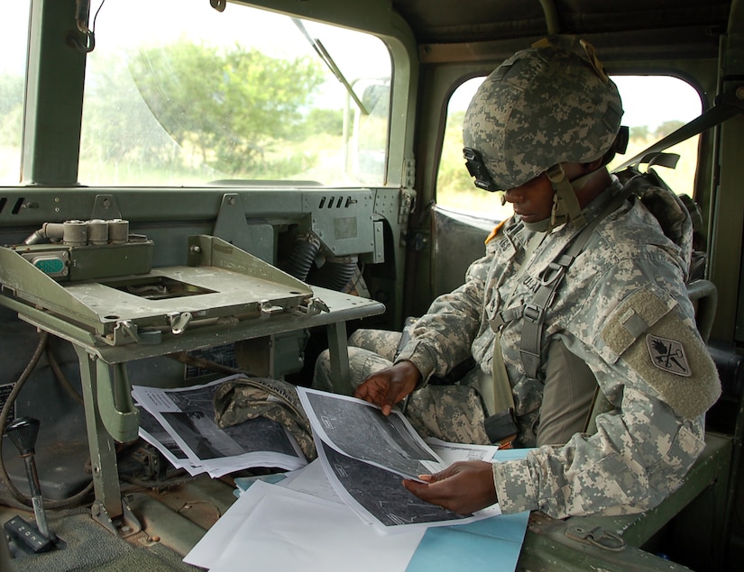 SOTO CANO AIR BASE, Honduras – Army Staff Sgt. Alma Jennings, truck commander for a Humvee leading one group of vehicles in a convoy exercise Oct. 19, checks her route on a map as the convoy rolls toward the village of Lejamani.  The purpose of the training was to keep the vehicles in operation and identify any issues with them so they could be fixed.  (U.S. Air Force photo by Staff Sgt. Austin M. May)