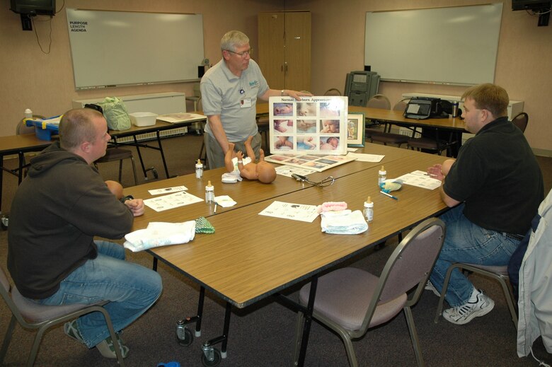 Joseph Furr describes the different appearances of healthy babies to Jason Fisher and Logan Pfeifer during a new-fathers class at Benefis Health Care in Great Falls Oct. 18. Mr. Furr is a retired U.S. Air Force lieutenant colonel and volunteers his time to teach new fathers how to care for their new arrivals. (U.S. Air Force photo/Airman 1st Class Dillon White)
