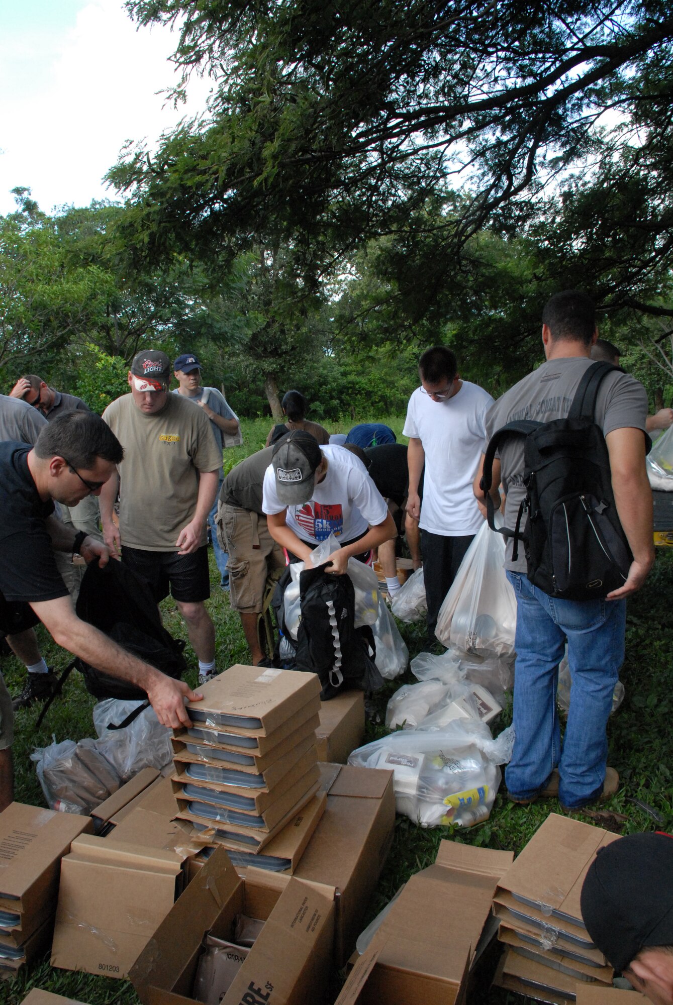 ALDEA BELLA VISTA, Honduras -- U.S. military personnel load their packs and backpacks with food Oct. 20 to deliver to people in the village of Bella Vista.  The hike was organized by the JTF-Bravo chaplain to support local Hondurans.  Approximately 50 military members participated in the hike which was the second in a series of five planned to date. (U.S. Air Force photo/1st Lt. Erika Yepsen)