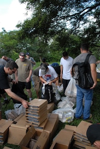 ALDEA BELLA VISTA, Honduras -- U.S. military personnel load their packs and backpacks with food Oct. 20 to deliver to people in the village of Bella Vista.  The hike was organized by the JTF-Bravo chaplain to support local Hondurans.  Approximately 50 military members participated in the hike which was the second in a series of five planned to date. (U.S. Air Force photo/1st Lt. Erika Yepsen)