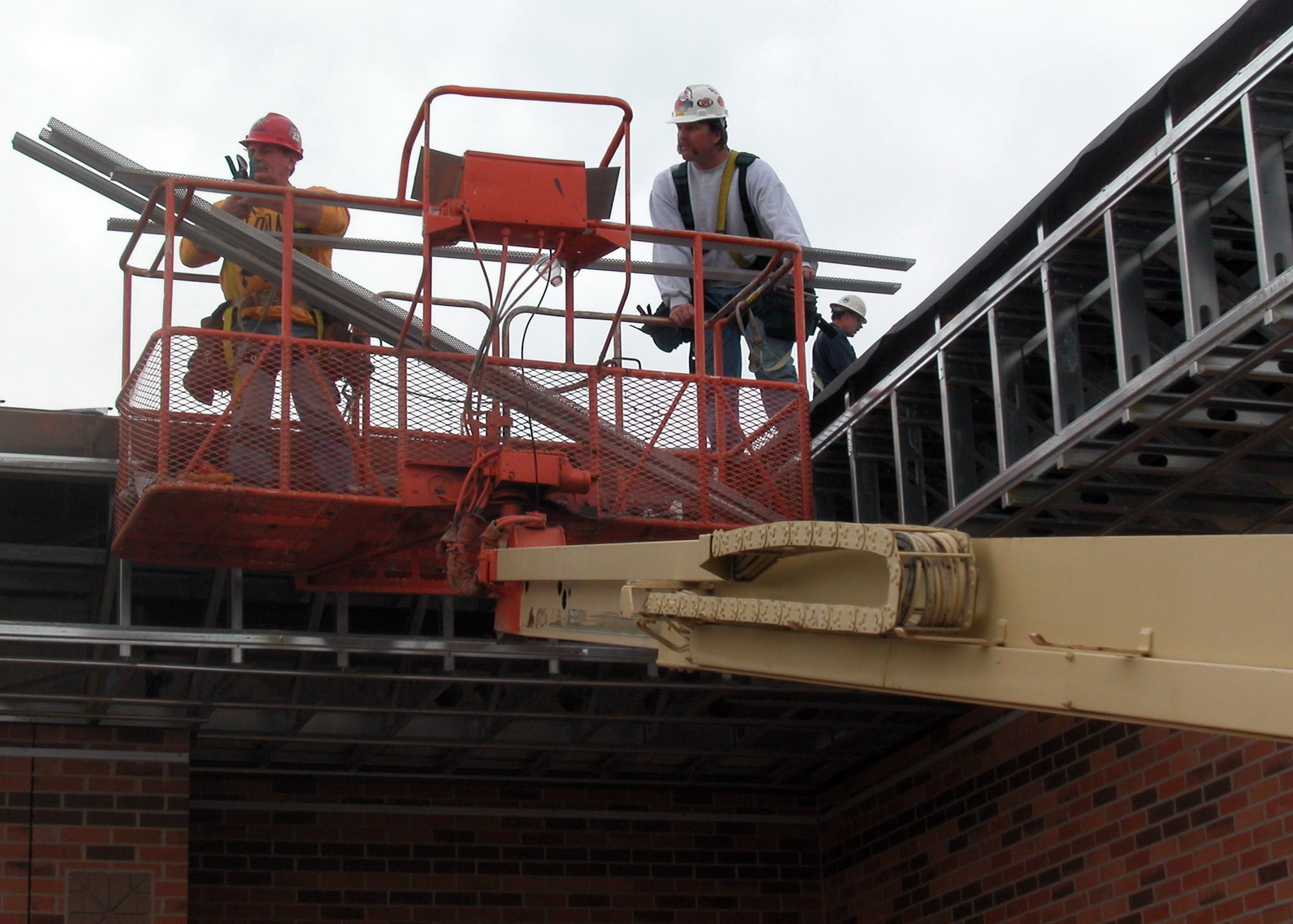 GRISSOM AIR RESERVE BASE, Ind., -- Construction workers Mike Jones, left, and Shawn McCool, fabricate a piece of perforated ridge vent for Bldg. 600.  Construction for the base operations facility is expected to be completed in late January of 2008. (Air Force photo / Senior Airman Ben Mota)