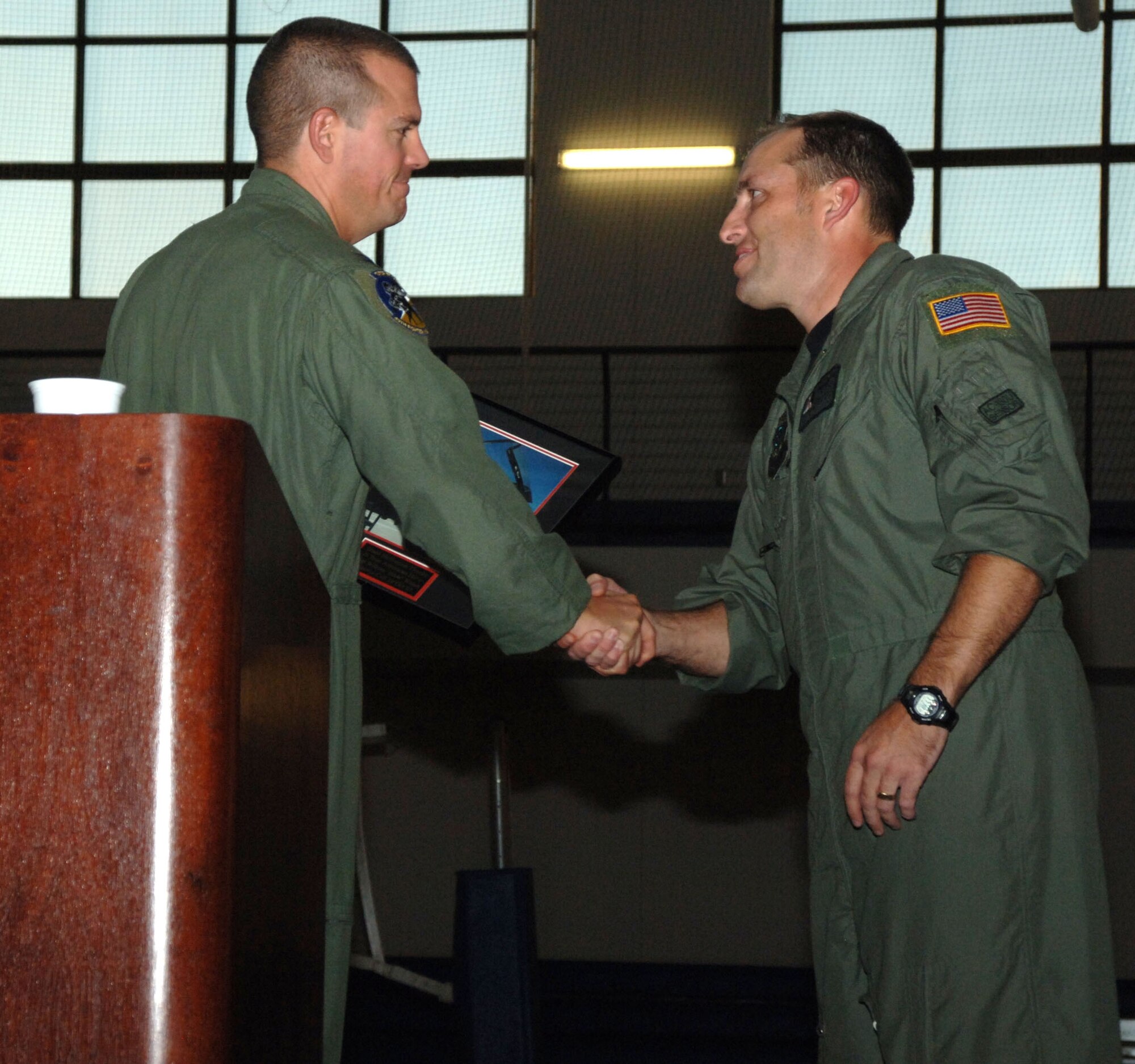 Tech. Sgt. WIlliam Wilson is given a photo of his T-38 ride from Col. Michael McGee, 49th Fighter Wing vice commander, during a Warrior Call Oct. 19. The Warrior Call featured two heroes, Tech. Sgt. William Wilson, a sensor operator on AC-130Us from Hurlbert Field, Fla., and Army Staff Sgt. Timothy Nein, a military police with the 223rd Military Police Company with the Louisville, Ky., National Guard. (U.S. Air Force photo/Airman 1st Class Tiffany Trojca)
