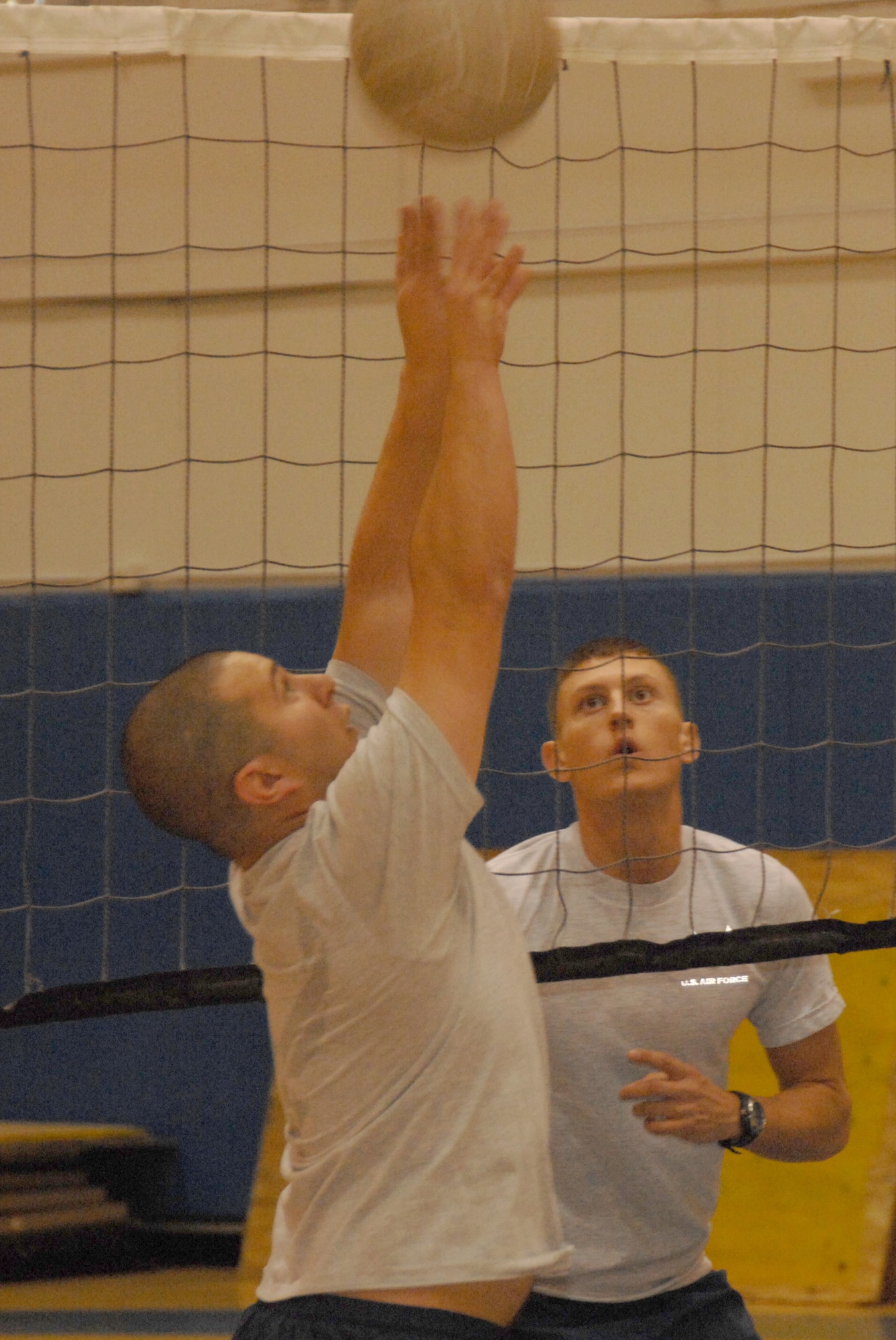 EIELSON AIR FORCE BASE, Alaska --  Senior Airman Gregory Gibbs, 354th Maintenance Squadron, sets a volleyball while Senior Airmen Johnathon Lind, 354th Logistic Readiness Squadron, prepares to spike it Oct. 18, 2007 at the fitness center. Airman Gibbs and Lind are two of many students in his class attending Airman Leadership School, all Airmen in the class PT as a group atleast three days a week afterwards practicing their volleyball skills preparing for the Airmen vs. Chief showdown.  (U.S. Air Force photo by Airman 1st Class Christopher Griffin)(Released)