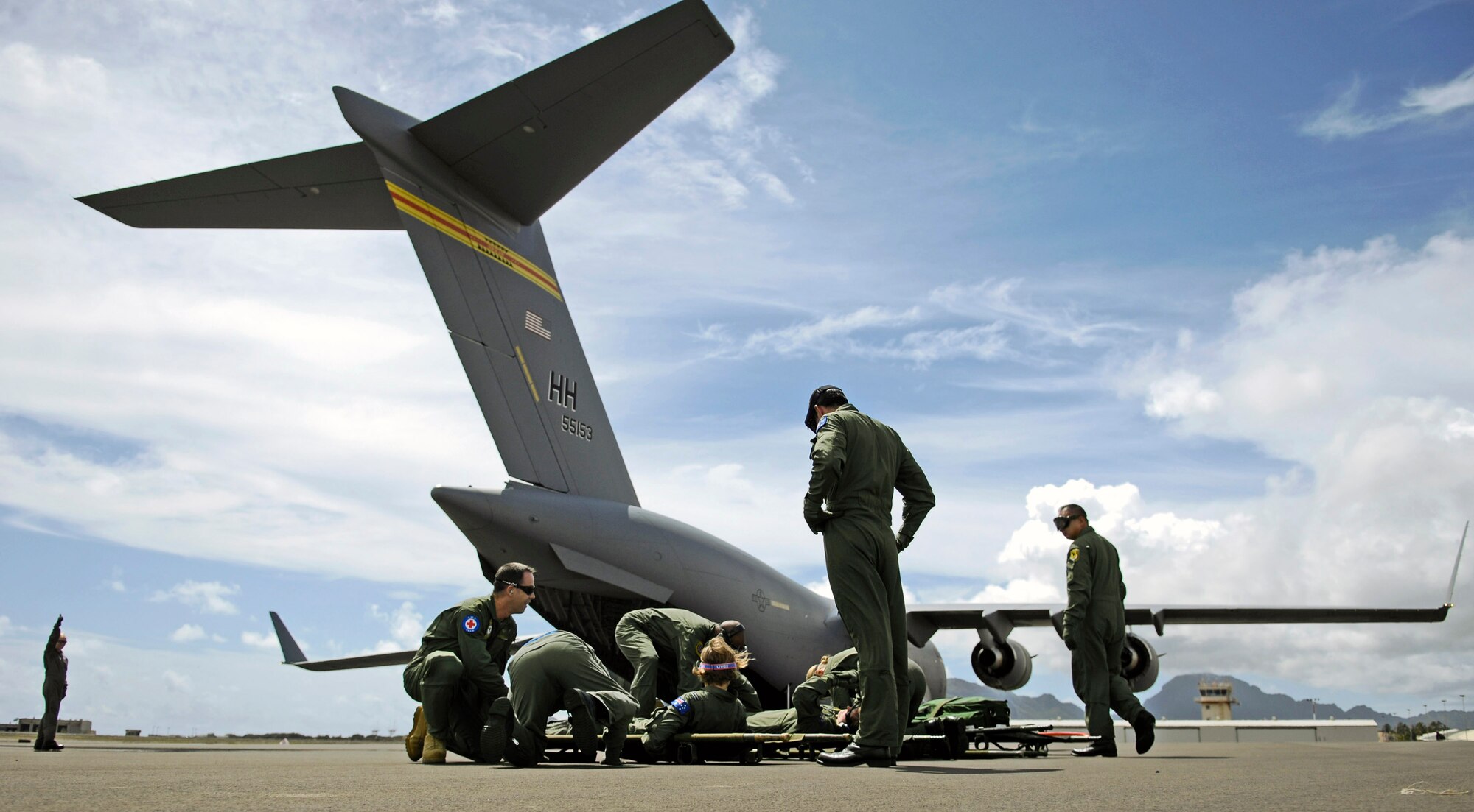 Air Force instructors observe as Royal Australian Air Force medical personnel prepare to load patients on to a C-17 Globemaster III Oct. 16 during aeromedical evacuation operations training at Kona International Airport, Hawaii.  Airmen from the 18th Aeromedical Squadron from Kadena Air Base, Japan, are there to train RAAF medical personnel who will be using specialized equipment and the C-17 for aeromedical evacuation. (U.S. Air Force photo/Tech. Sgt. Shane A. Cuomo) 