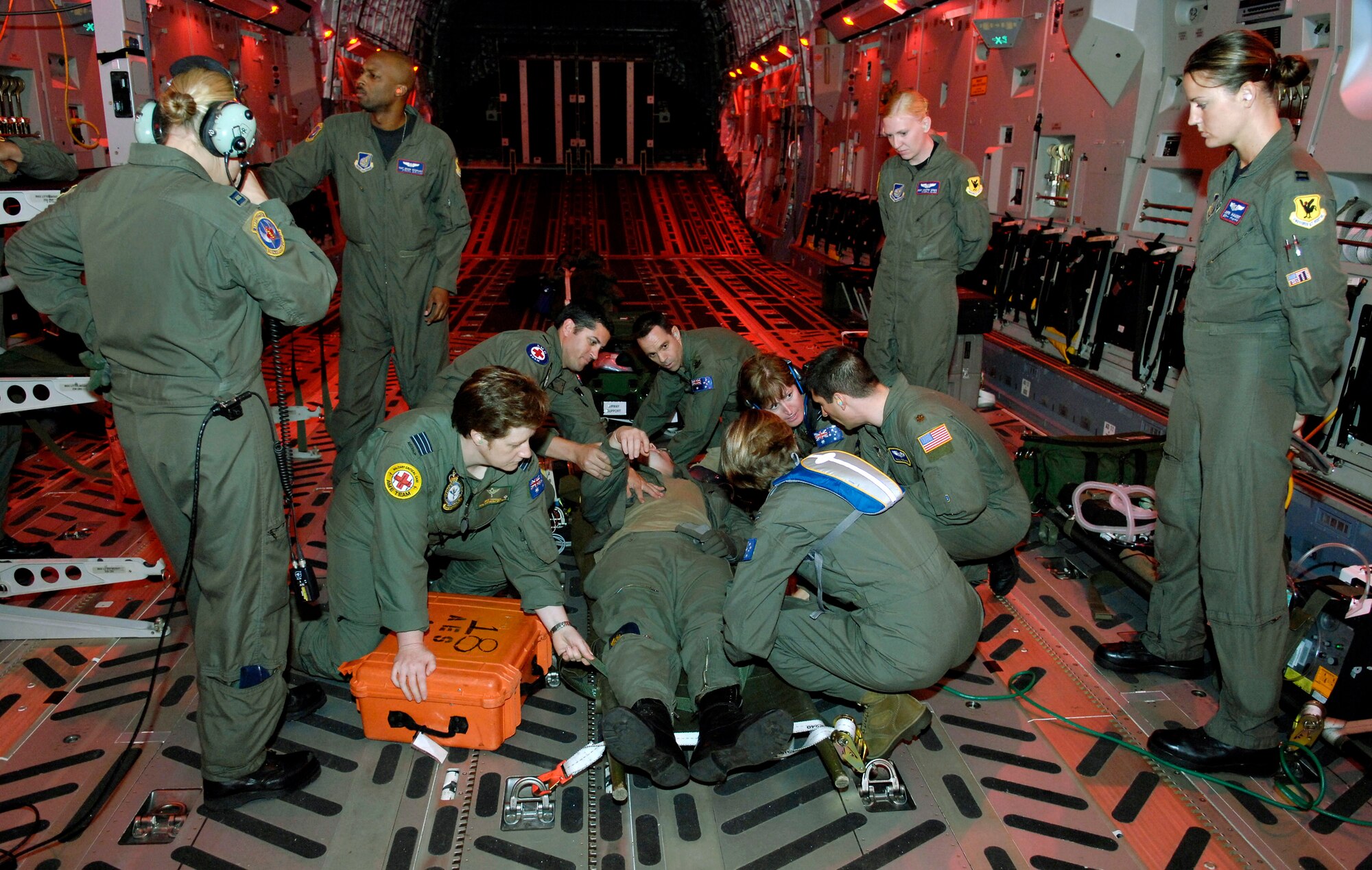 Air Force instructors observe as Royal Australian Air Force medical personnel tend to a simulated patient onboard a C-17 Globemaster III Oct. 16 during aeromedical evacuation operations training at Hickam Air Force Base, Hawaii. Airmen from the 18th Aeromedical Squadron from Kadena Air Base, Japan, are at Hickam to train RAAF medical personnel who will be using specialized equipment and the C-17 for aeromedical evacuation. (U.S. Air Force photo/Tech. Sgt. Shane A. Cuomo) 