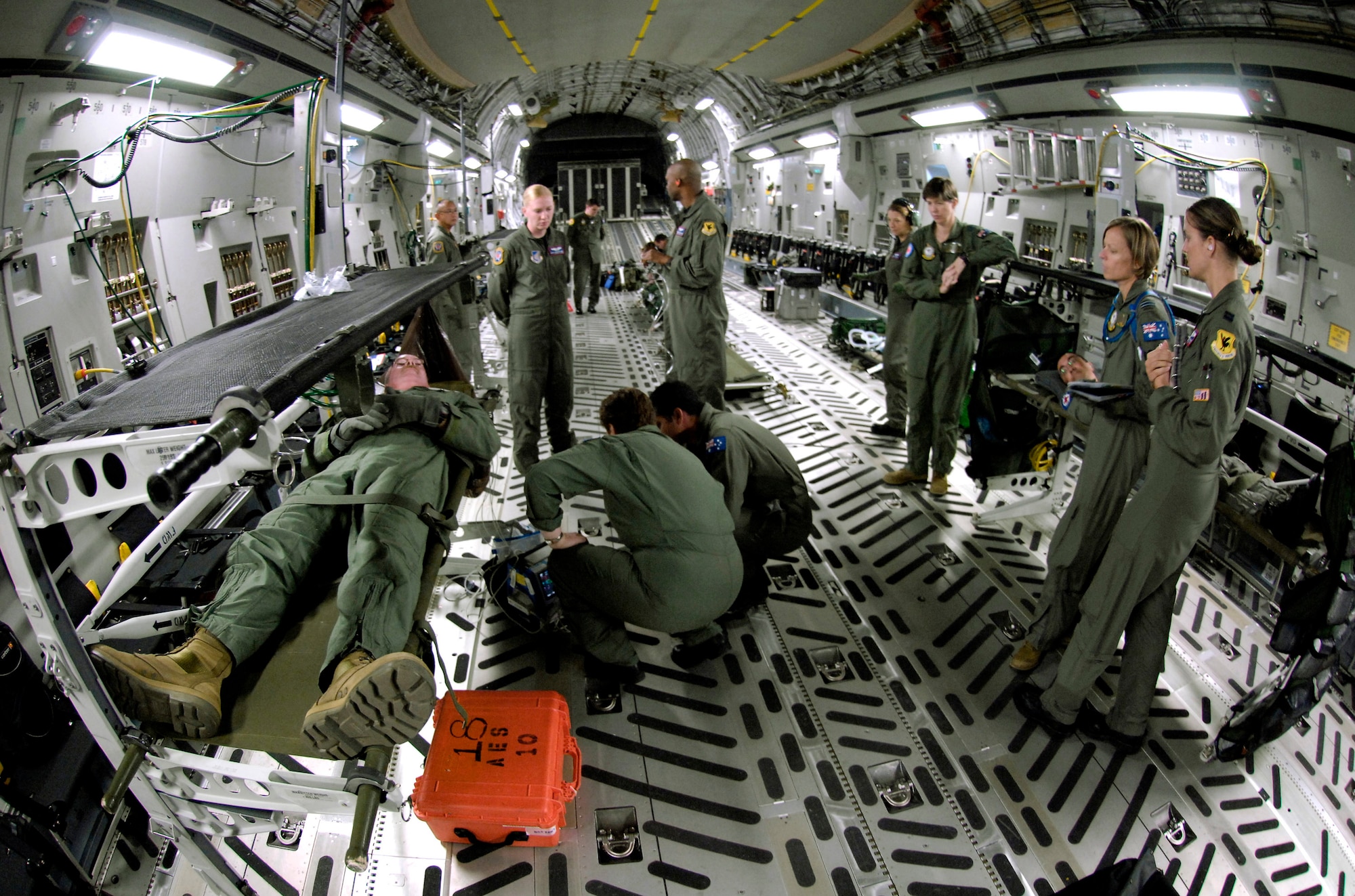 Air Force instructors observe as Royal Australian Air Force medical personnel tend to a simulated patient onboard a C-17 Globemaster III Oct. 16 during aeromedical evacuation operations training at Hickam Air Force Base, Hawaii. Airmen from the 18th Aeromedical Squadron from Kadena Air Base, Japan, are at Hickam to train RAAF medical personnel who will be using specialized equipment and the C-17 for aeromedical evacuation. (U.S. Air Force photo/Tech. Sgt. Shane A. Cuomo) 