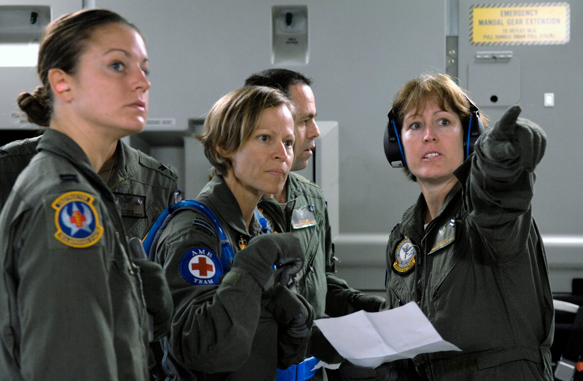 Capt. Jennifer Haubert (left) observes Royal Australian Air Force medical personnel going over a set-up checklist on a C-17 Globemaster III Oct. 16 during aeromedical evacuation operations training at Hickam Air Force Base, Hawaii. Airmen from the 18th Aeromedical Squadron at Kadena Air Base, Japan, are at Hickam to train RAAF medical personnel who will be using specialized equipment and the C-17 for aeromedical evacuation.  Captain Haubert is with the 18th AMS.  (U.S. Air Force photo/Tech. Sgt. Shane A. Cuomo) 