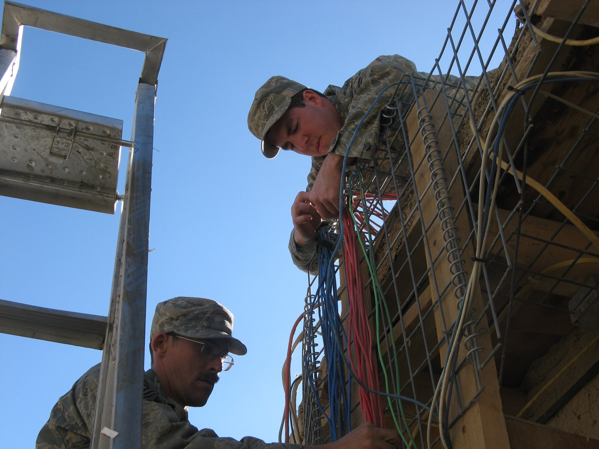 Master Sgt. James Wright (left), from Barksdale AFB, and Senior Airman Joshua Medlin, 21st Space Communications Squadron, constitute the communications shop for the Gardez PRT. (U.S. Air Force photo by Capt. Shamekia Toliver)