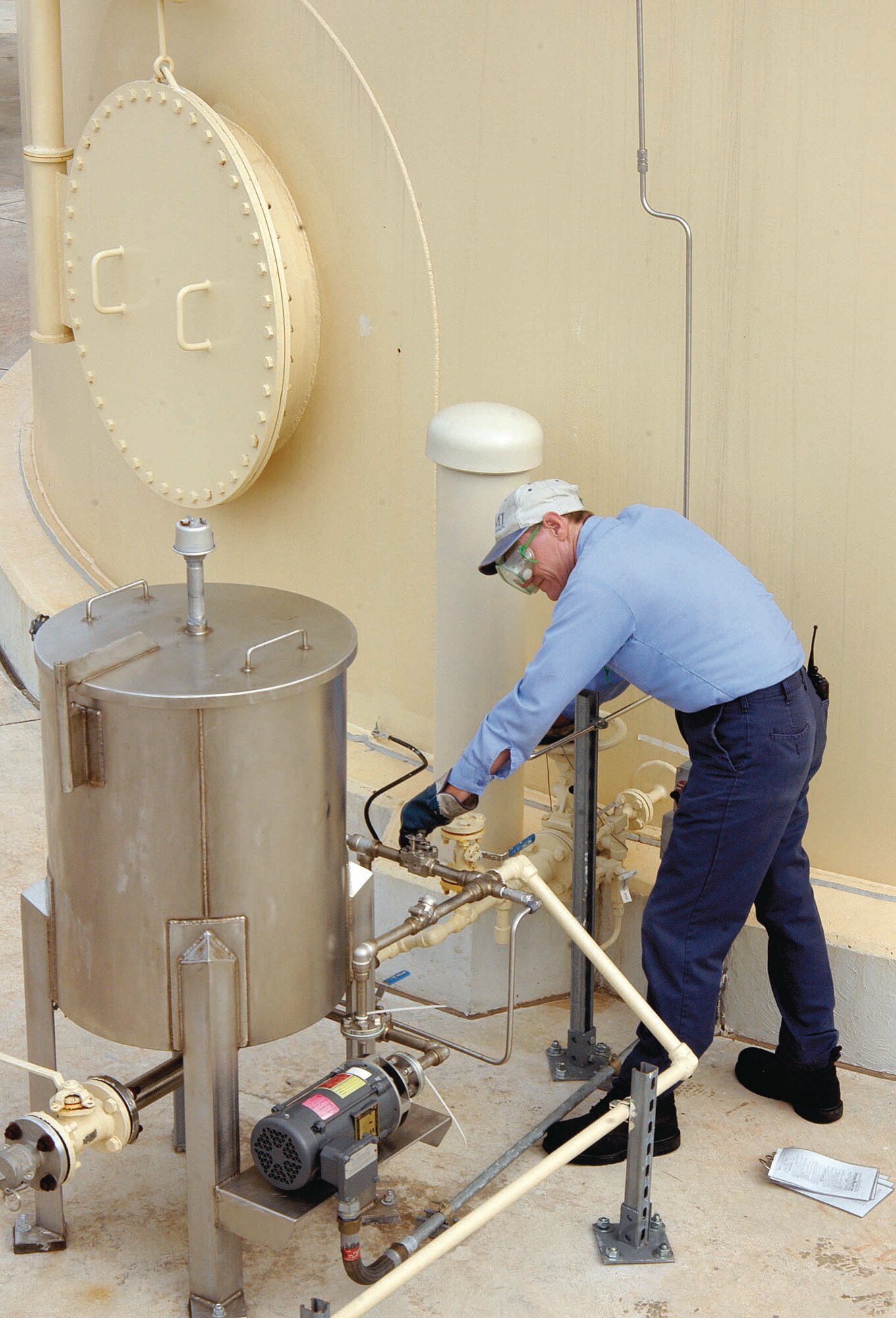 Tinker fuels specialist John Sutton bleeds water from a new 200,000-gallon fuel hydrant tank on base. The system is used for defueling aircraft and is one of the new upgrades to the refueling process on base. (Air Force photo by Margo Wright)