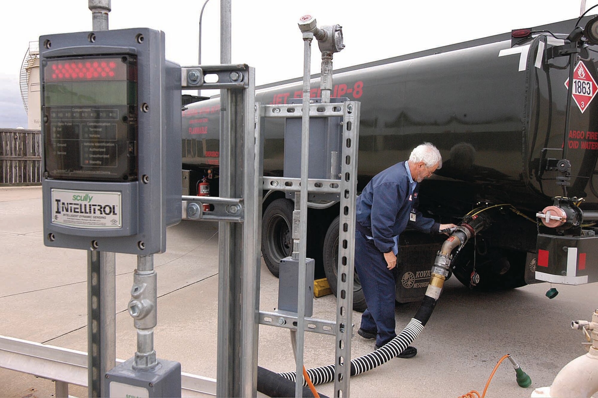 Jerry Calvert, a fuels specialist, readies a 6,000-gallon capacity fuel truck to take in JP-8 using one of nine new Scully sensors that have reduced fuel spills during filling. The new system also ensures the right fuel is pumped and reduces the number of personnel needed to do the fueling safely. (Air Force photo by Margo Wright)