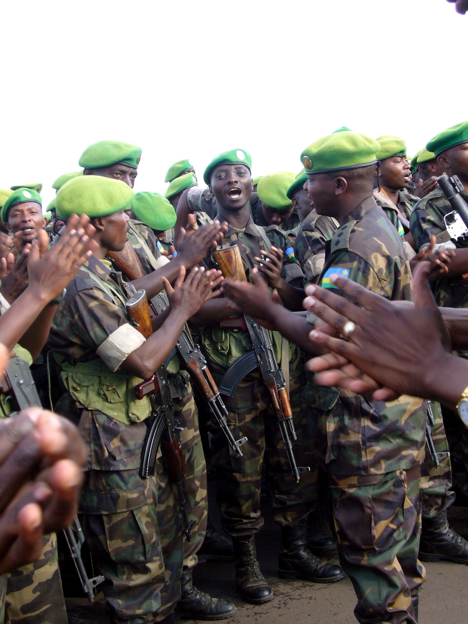 Rwandan soldiers celebrate with a traditional song after returning from their eight-month deployment in Darfur Oct. 20 in Kigali, Rwanda. Airmen from Ramstein Air Base, Germany, and Charleston Air Force Base, S.C., are providing airlift support to the African Union effort in Darfur. (U.S. Air Force photo/Capt. Erin Dorrance) 
