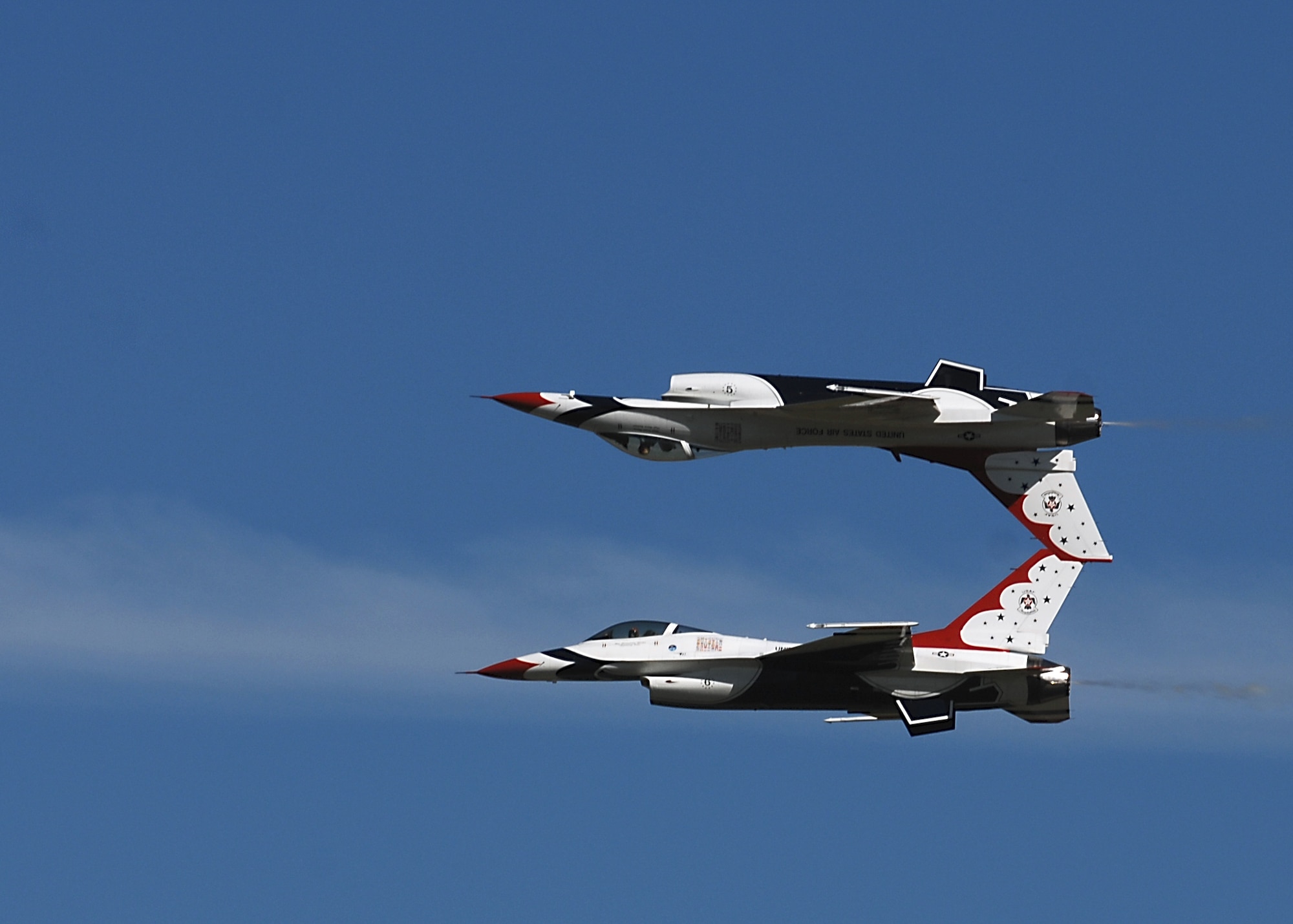 MOODY AIR FORCE BASE, Ga.-- Two members of the U.S. Air Force Aerial Demonstration Squadron Thunderbirds perform a calypso pass during the Team Moody AirFest 07' here on Oct. 20. A Thunderbirds air demonstration is a mix of six aircraft, performing formation flying and solo routines. The show highlights the training and precision of Air Force pilots, while showcasing the maximum capabilities of the Lockheed Martin F-16 Fighting Falcon. (U.S. Air Force photo by Airman First Class Brittany Barker)