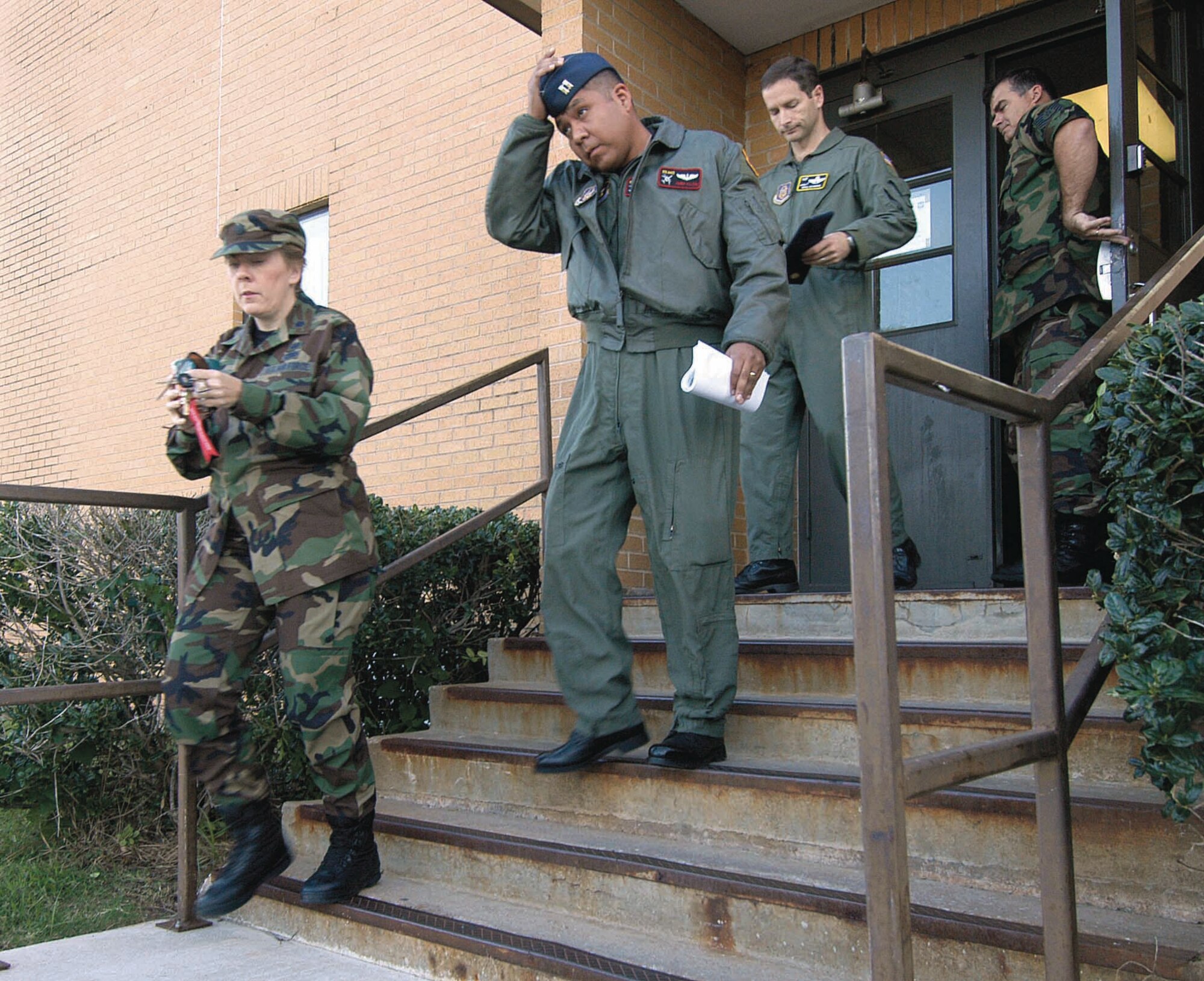 People stream out of Bldg. 1043 during a fire evacuation drill. Drills were held across base during Fire Prevention Week. (Air Force photo by Margo Wright)