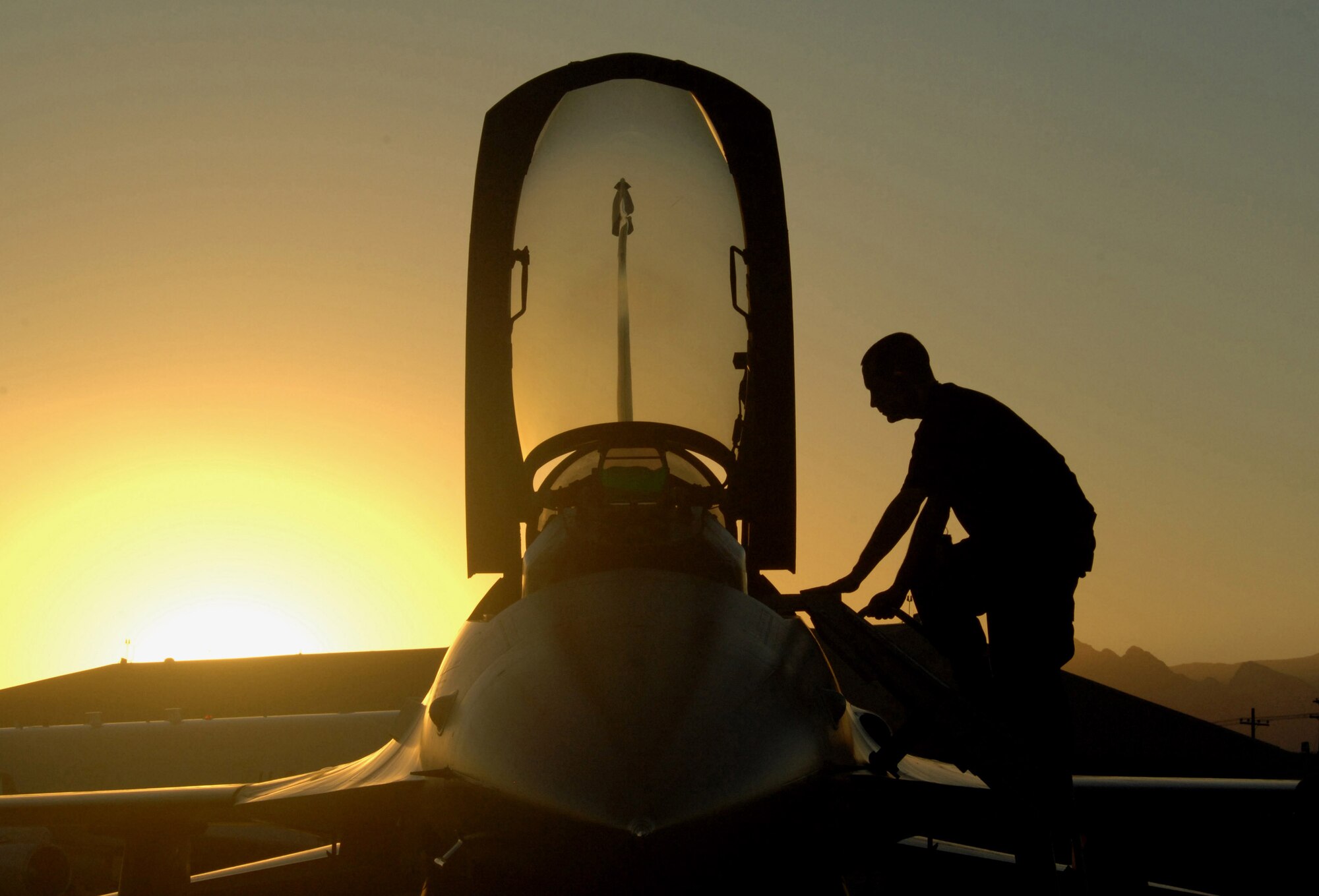Senior Airman Kyle Renbarger performs an F-16 Fighting Falcon post flight inspection Oct. 18 at Nellis Air Force Base, Nev. Airman Renbarger is a 63rd Fighter Squadron crew chief from Luke AFB, Ariz. The 63rd FS is at Nellis AFB supporting the F-15 Eagle Weapons School Instructor Course in an adversary tactics role. (U.S. Air Force photo/Master Sgt. Kevin J. Gruenwald)
