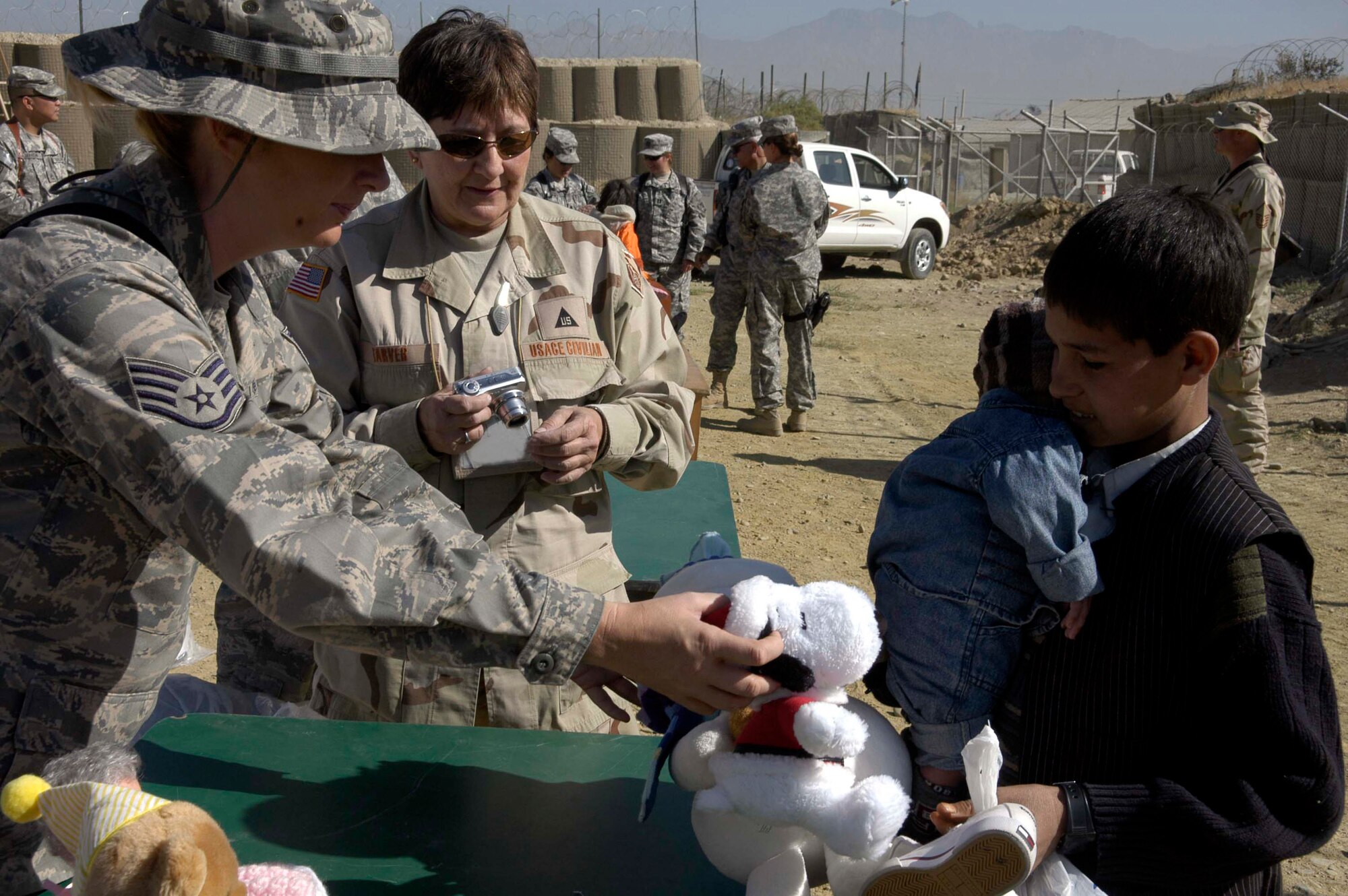 Staff Sgt. Tracy Anderson passes out toys to Afghan children during an Operation Care visit to the Korean Hospital Oct. 17 near Bagram Air Base, Afghanistan. Operation Care is an all-volunteer effort that provides clothes, school and hygien supplies, toys and candy to Afghan villagers. (U.S. Air Force photo/Capt. Michael Meridith)
