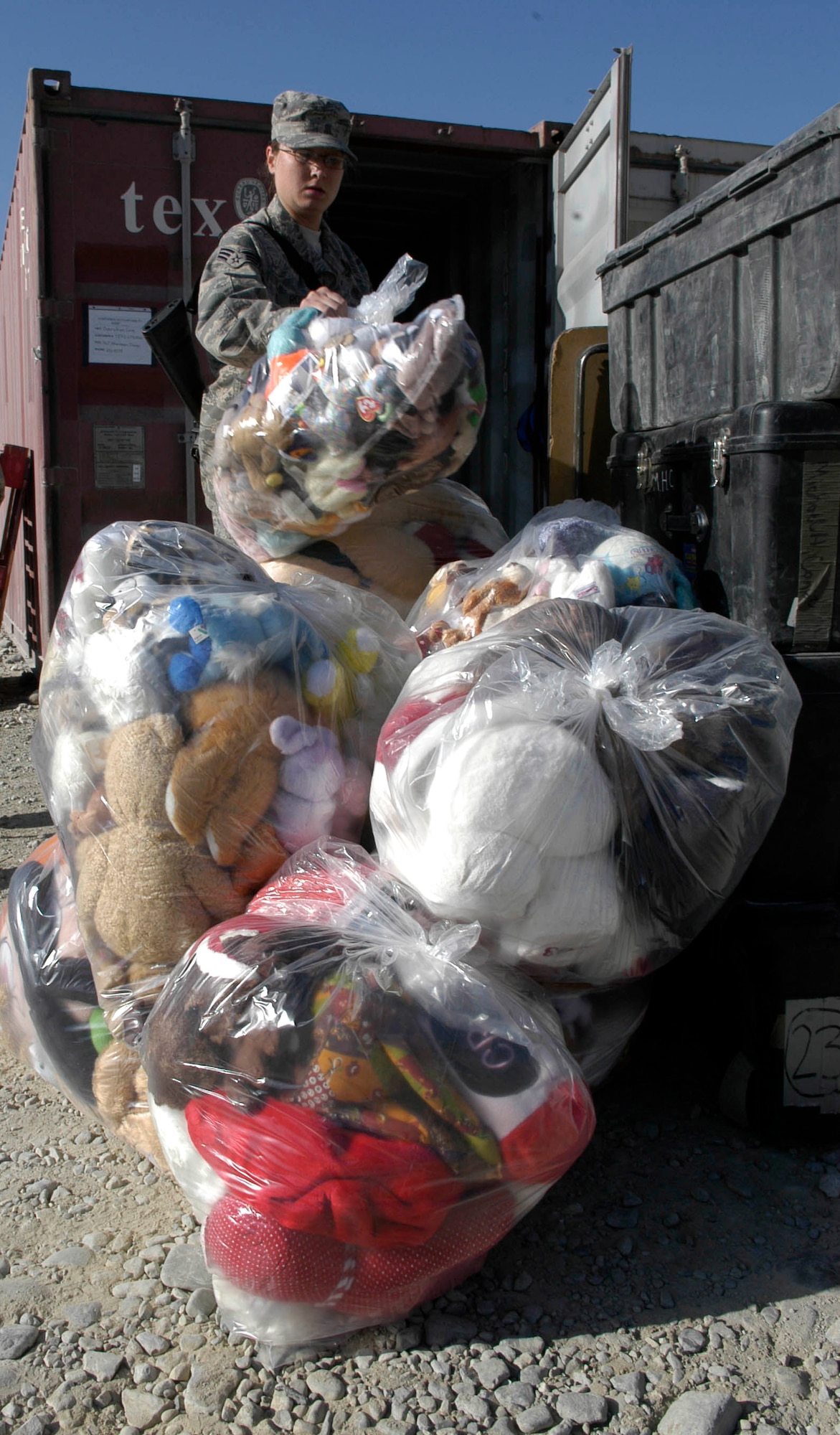 Senior Airman Elisa Rosemond stacks bags of toys for Afghan children prior to an Operation Care visit to the Korean Hospital Oct. 17 near Bagram Air Base, Afghanistan. Operation Care is an all-volunteer effort that provides clothes, school and hygiene supplies, toys and candy to Afghan villagers. (U.S. Air Force photo/Capt. Michael Meridith)
