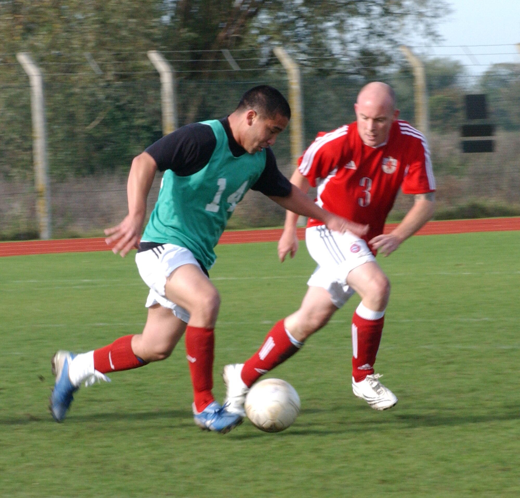 Fire Department’s Todd Sorbin (14), races away from Chris Reeve, 727th player during the fiercely competitive soccer championships held at the RAF Mildenhall sports field Oct. 18. (U. S. Air Force photo by Airman 1st Class Brad Smith)