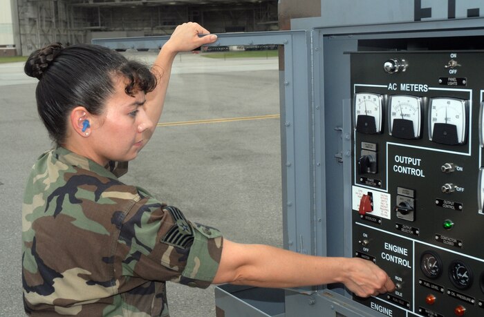 Tech. Sgt. Patricia McClure, 437th Aerial Port Squadron combat readiness instructor, turns on a generator to apply power to a C-17 Oct. 19 on the Charleston AFB flightline. (U. S. Air Force photo/Airman Melissa White)