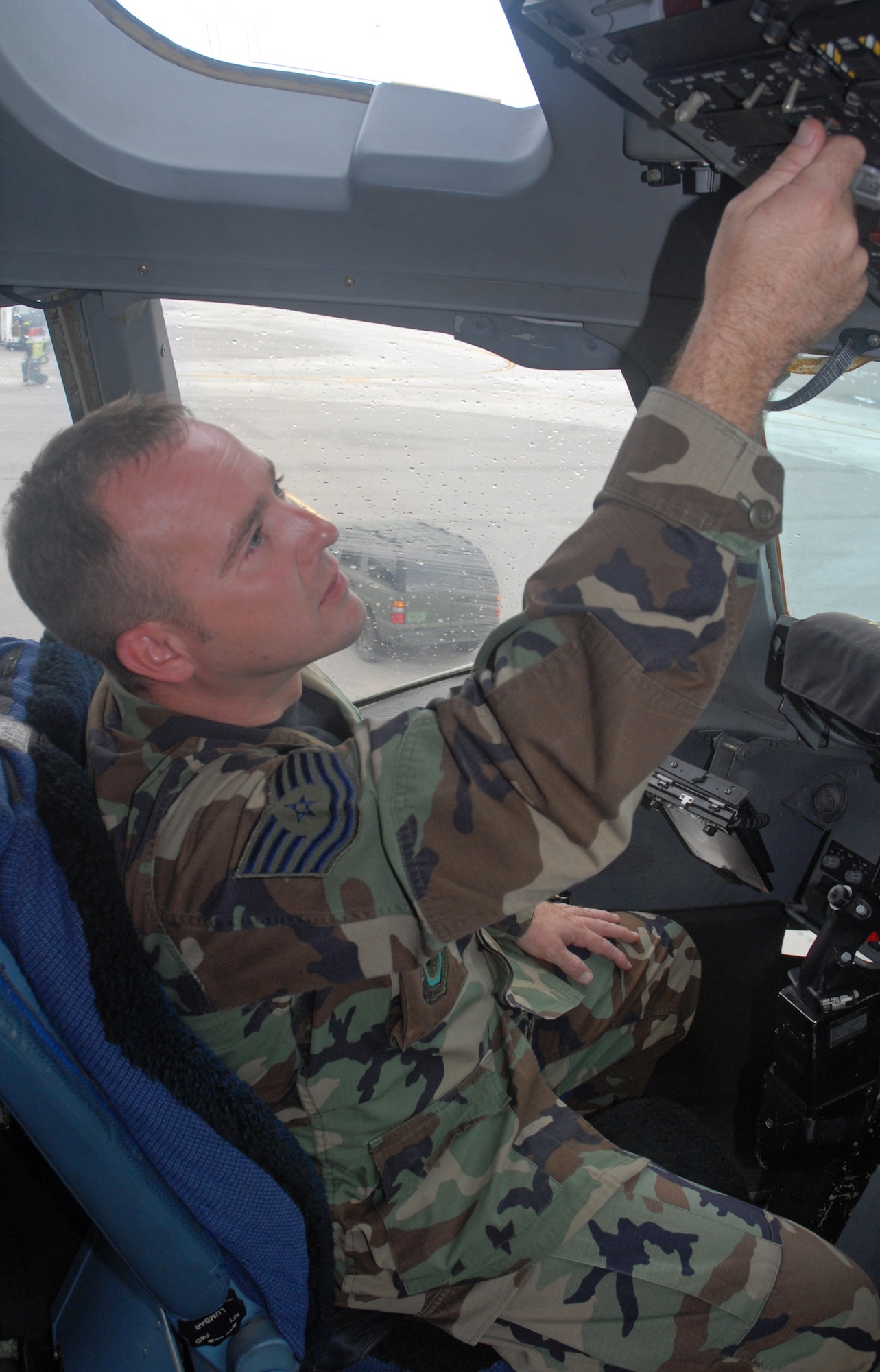 Tech. Sgt. Brian Abraham, 437th Aerial Port Squadron "Port Dawg" University instructor, applies external power to a C-17 Oct. 19 on the Charleston AFB flightline. (U.S. Air Force photo/Airman Melissa White)