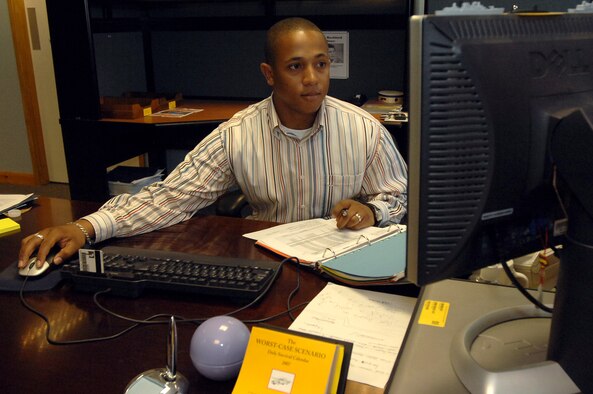 Christopher Owens, 100th Communications Squadron, reviews the list of base-wide computers in the database here. Mr. Owens is the base equipment control officer. Male dependent spouses often assume the role of “house husbands” as well as providing an income while their wives are away on deployments. (U.S. Air Force photo by Senior Airman Teresa M. Hawkins)