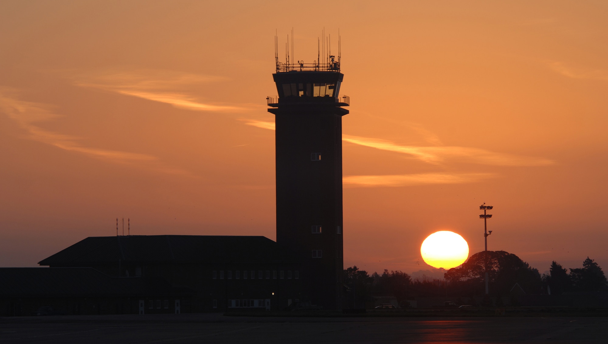Winter approaches -- evident by the sun skimming the horizon of RAF Mildenhall setting the control tower in a distant light, Oct. 5, 2007.
(U.S. Air Force photo by Tech. Sgt. Tracy L. DeMarco)

