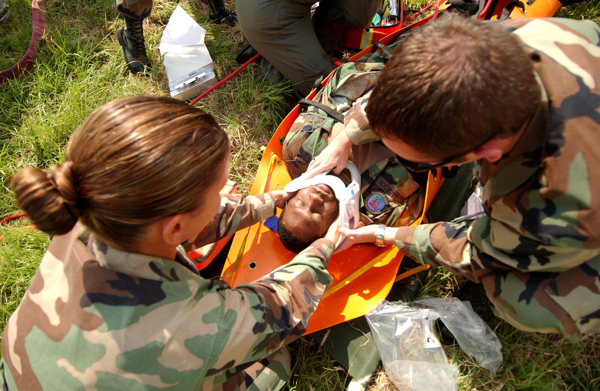 Staff Sgt. Leslie Emery and Airman 1st Class Michael Stull, 18th Aerospace Medicine Squadron, provide care for an unconscious "victim" during the Local Operational Readiness Exercise here Oct. 22. In the scenario an explosion at a fuel farm caused injuries to several people.  (U.S. Air Force photo/Tech. Sgt. Rey Ramon)