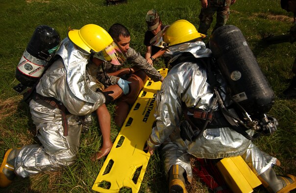 The emergency response to a simulated gas explosion brings base agencies together to administer first aid to "victims" during the Local Operation Readiness Exercise Oct. 22.  (U.S. Air Force photo/Tech. Sgt. Rey Ramon)

