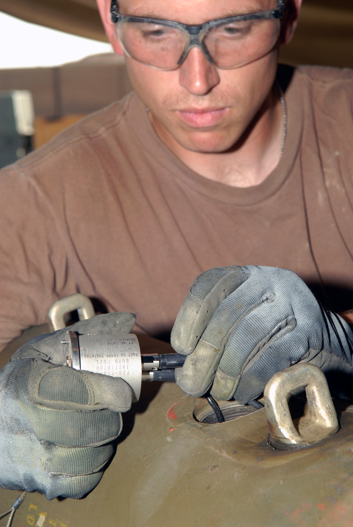 BALAD AIR BASE, Iraq -- Staff Sgt. Travis Tarr, 332nd Expeditionary Maintenance Squadron, connects a proximity sensor during the build of a Joint Direct Attack Monition here. The proximity sensor allows the bomb to explode prior to coming in contact with the ground. Sergeant Tarr is currently deployed from Spangdahlem Air Base, Germany (U.S. Air Force photo/Staff Sgt. Joshua Garcia) 