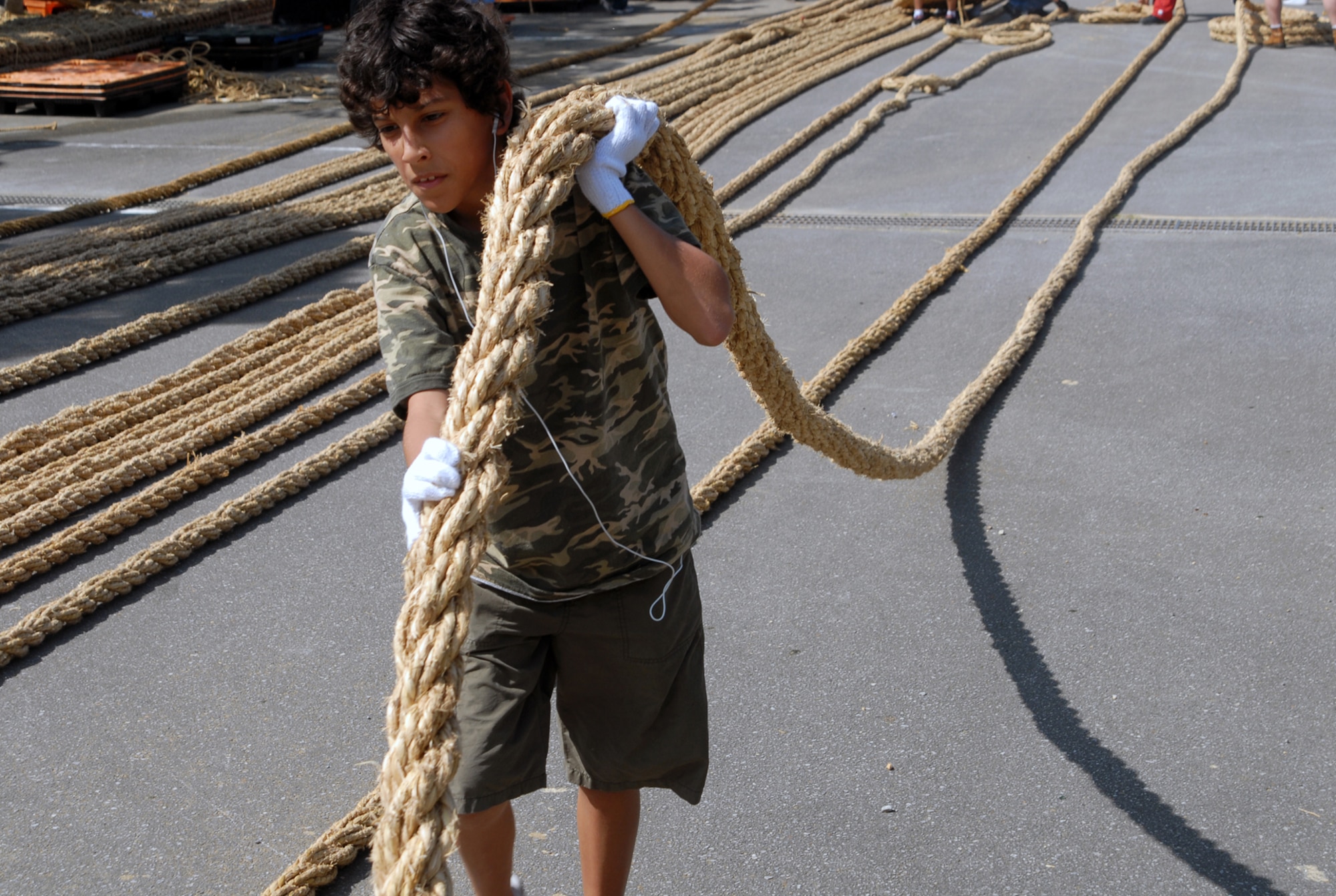 Kristopher Swanner pulls out a medium rope which will be combined to be part of a larger rope.  Members of Team Kadena volunteered to participate in making a 100 meter long rope to be used for a tug-of-war at the upcoming Okinawa City International Carnival Oct. 20.  (U.S. Air Force photo/Staff Sgt. Christopher A. Marasky)